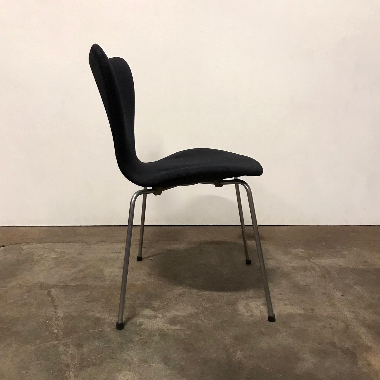 Set of three butterflies in black upholstery by Fritz Hansen. These butterflies, with their elegant design, show traces of wear like some tiny damage and stains on the fabric of the upholstery (picture #8). One chair is quite good (#9), the second