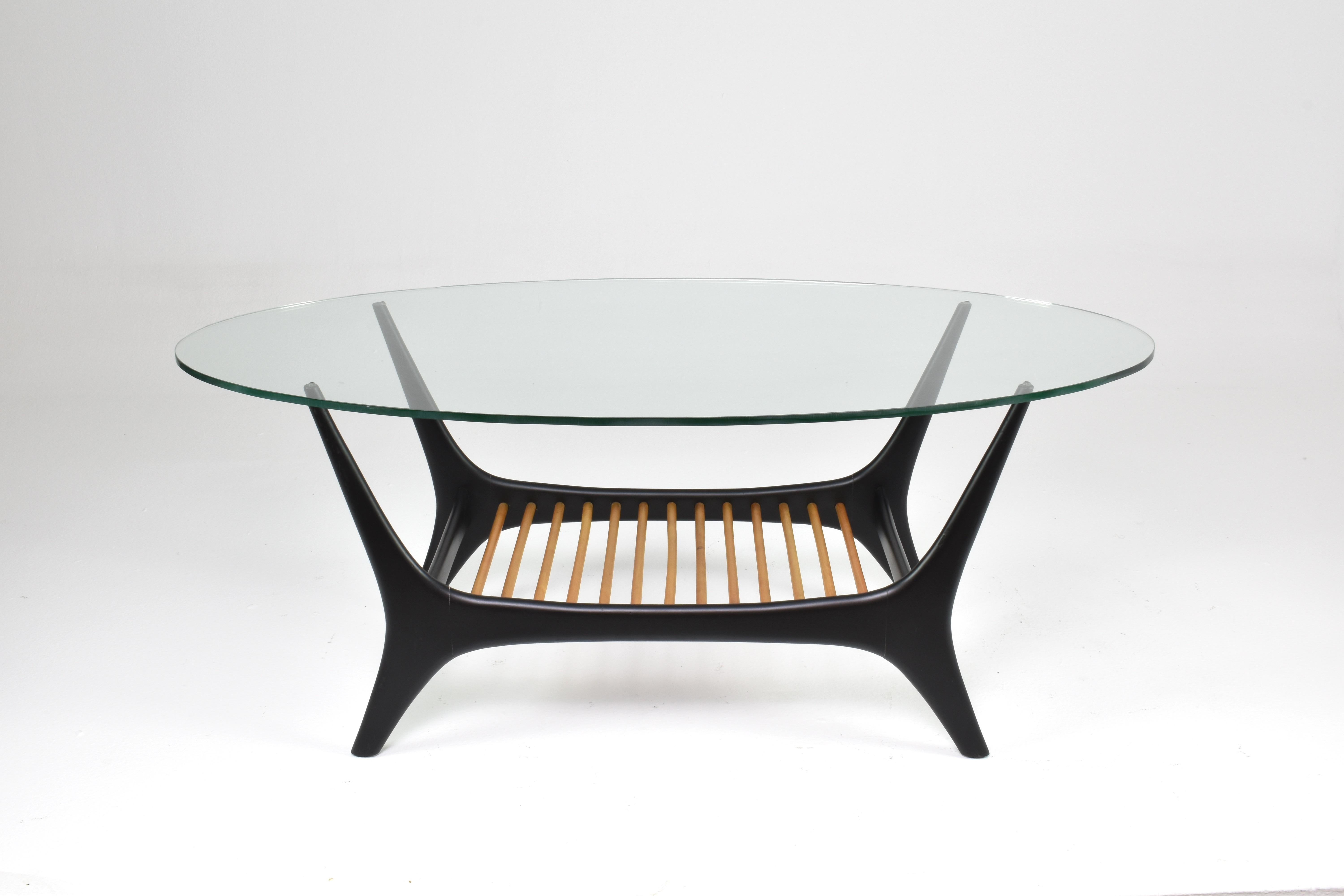 The 'Number 208' coffee table, is a notable piece of mid-century modern design, crafted by Alfred Hendrickx for the esteemed Belgian manufacturer Belform around 1955. This meticulously restored two-tiered table features a robust wooden panel on the