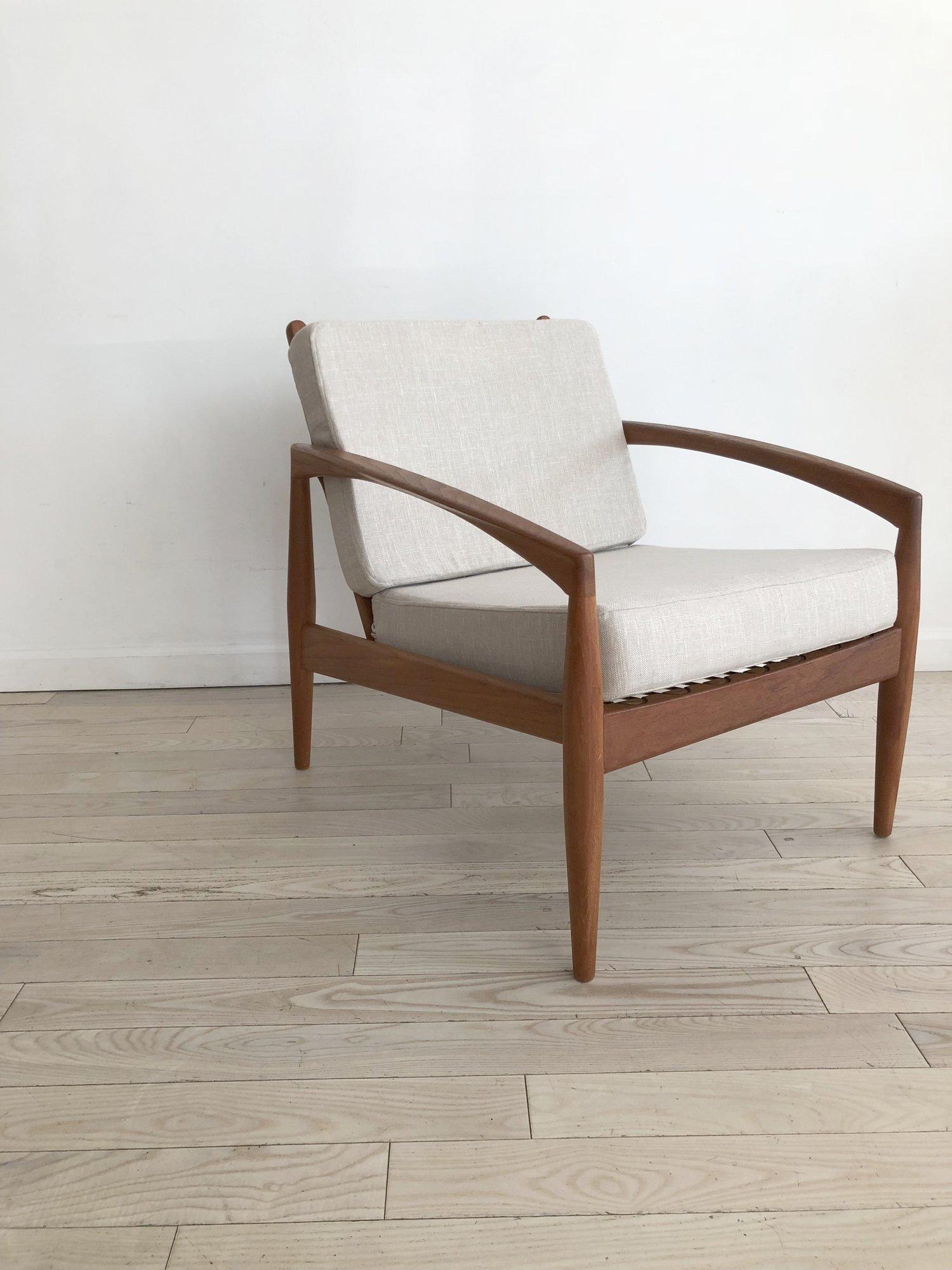 1950s Kai Kristansen teak “Paper Knife” easy chair for Magnus Olesen. Made in Denmark. New memory foam cushions and cream linen upholstery. Zippers in back of covers. Love the silhouette of this chair, the arms become the legs! Perfect condition.