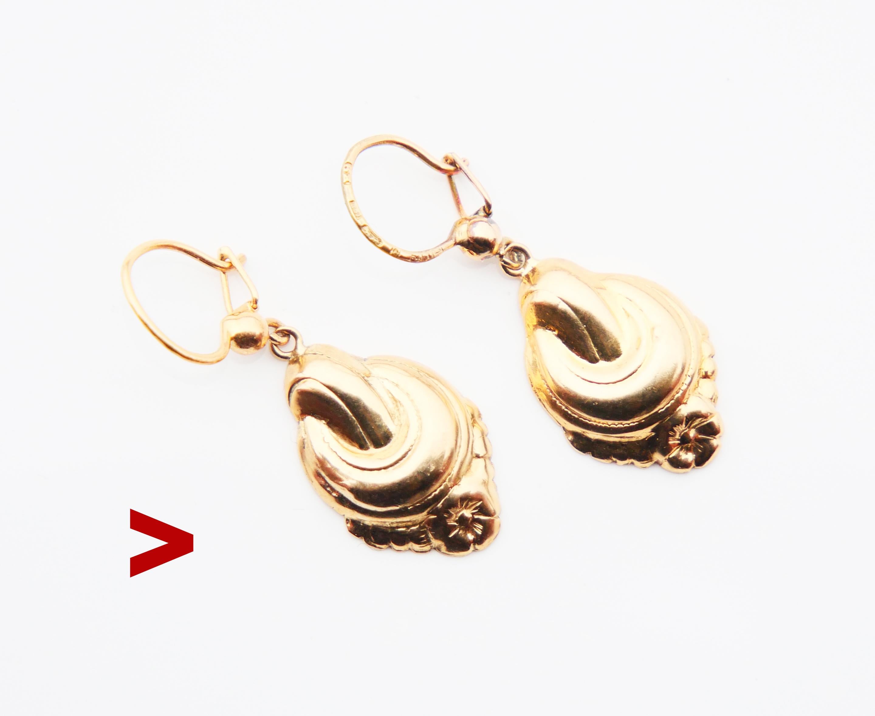 A pair of pendants dangles in solid 18K Yellow Gold with cast identical floral ornaments on front sides and flat backs.

Hooks can be later mod, hallmarked 18K, Swedish maker's hallmarks,year combo E8 / made in 1955. Pendants may well be older