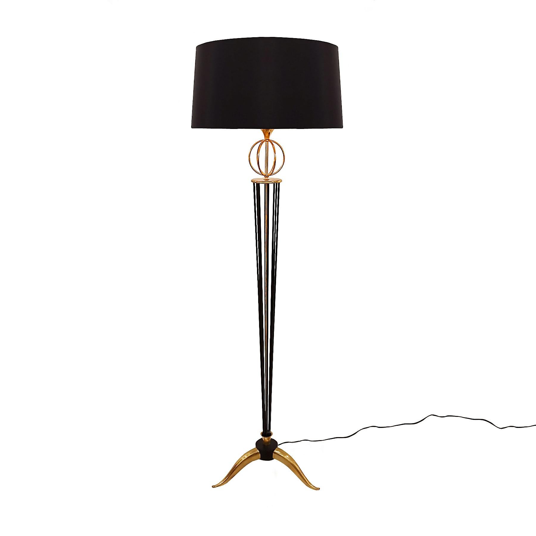 Standing lamp in black lacquered steel and polished bronze, lampshade in black silk and golden inside, made according to the original model. Bayonet bulbs.
Brand: Arlus
France, 1955.

Publication: Meubles & Décors Nº 686, October 1955.