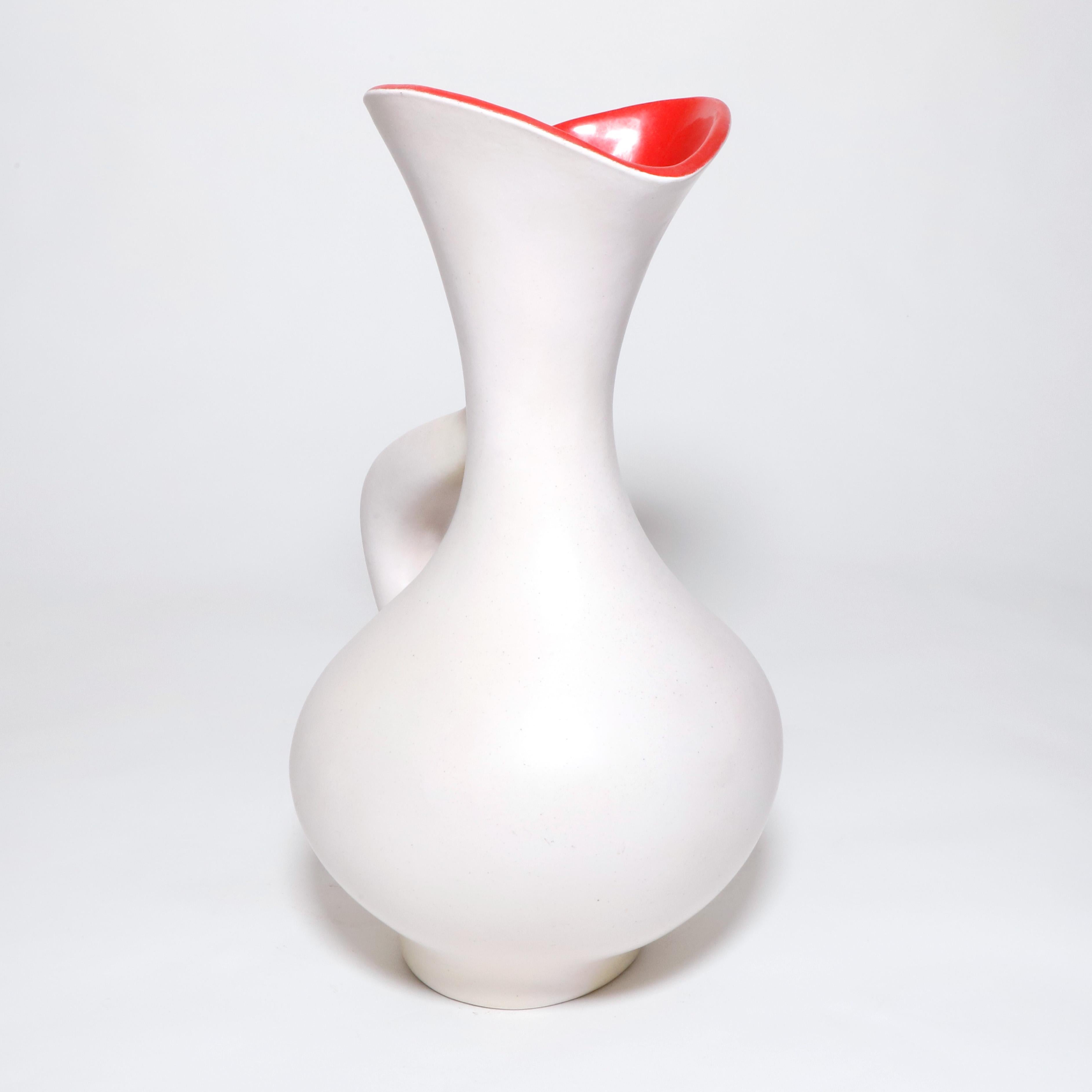 White ceramic earthenware vase with red glaze interior by the French sculptor Pol Chambost. Made in 1956 this is the 894 model a unique shaped pitcher with intricate curves and handle with an elegant flared spout. Signed on bottom by the artist.