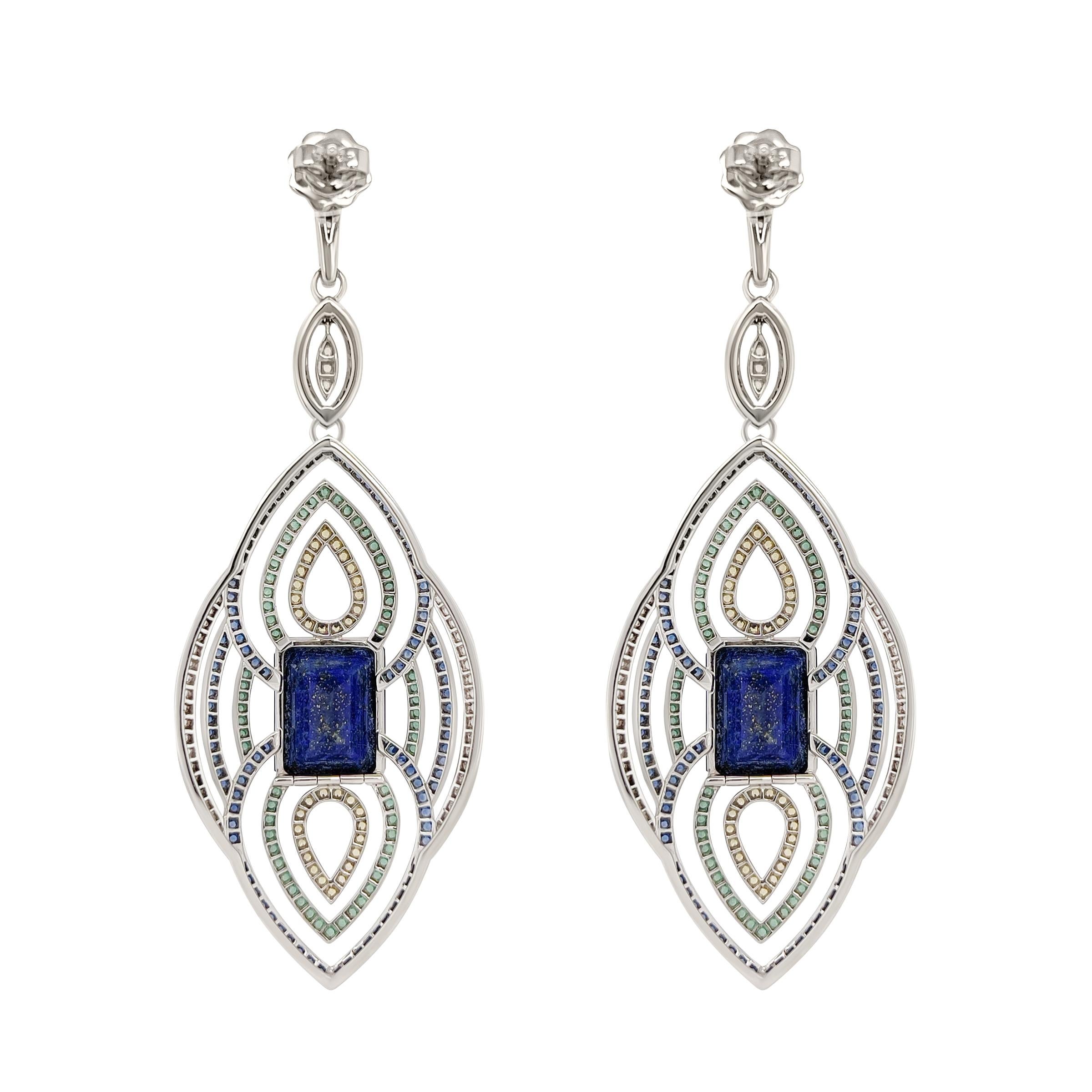 Natural blue, yellow, white and green sapphires and diamonds are pave set around this pair of 18k white gold and lapis earrings. Inspired by ancient Egypt, the centre stone of lapis weighing a total of 19.56 carats.
