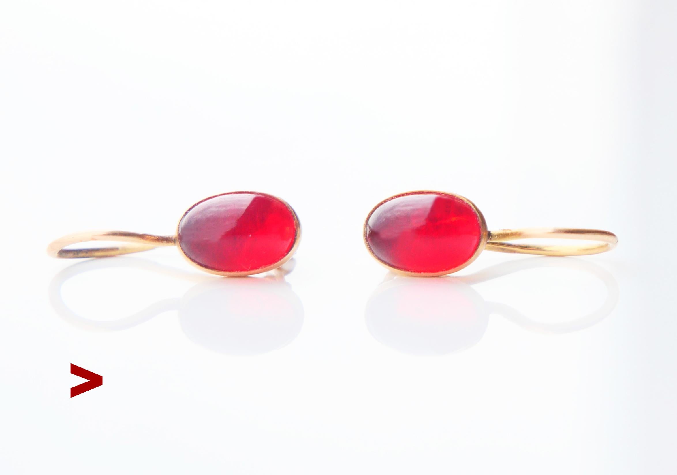 A pair of Soviet dangles in solid 14K Yellow Gold decorated with cabochon cut Red Paste / Glass settings that very realistically imitate natural Red Rubies.  

 Soviet period standard hallmarks with head of a worker >  this pair is made in 1956 of