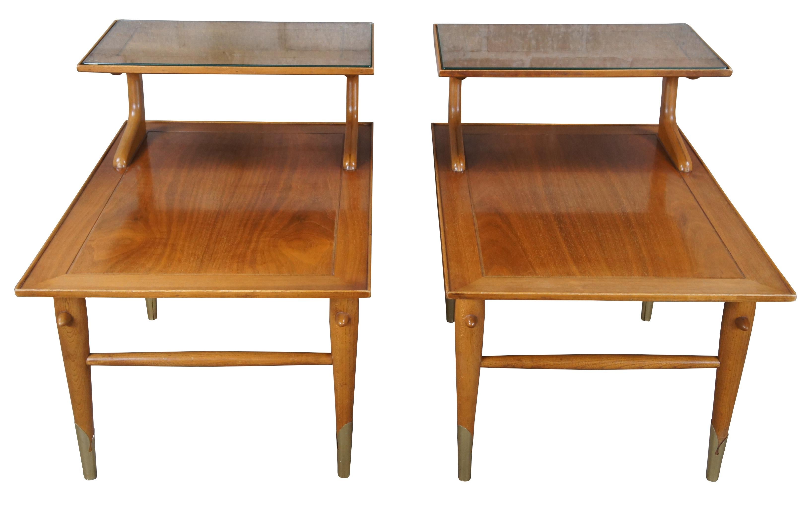 Mid century modern tiered Lane Altavista Copenhagen step tables featuring a two tiered design with brass wrapped tapered legs and glass inserts.  

Style 867, circa 01/26/1957 (serial no 756201)