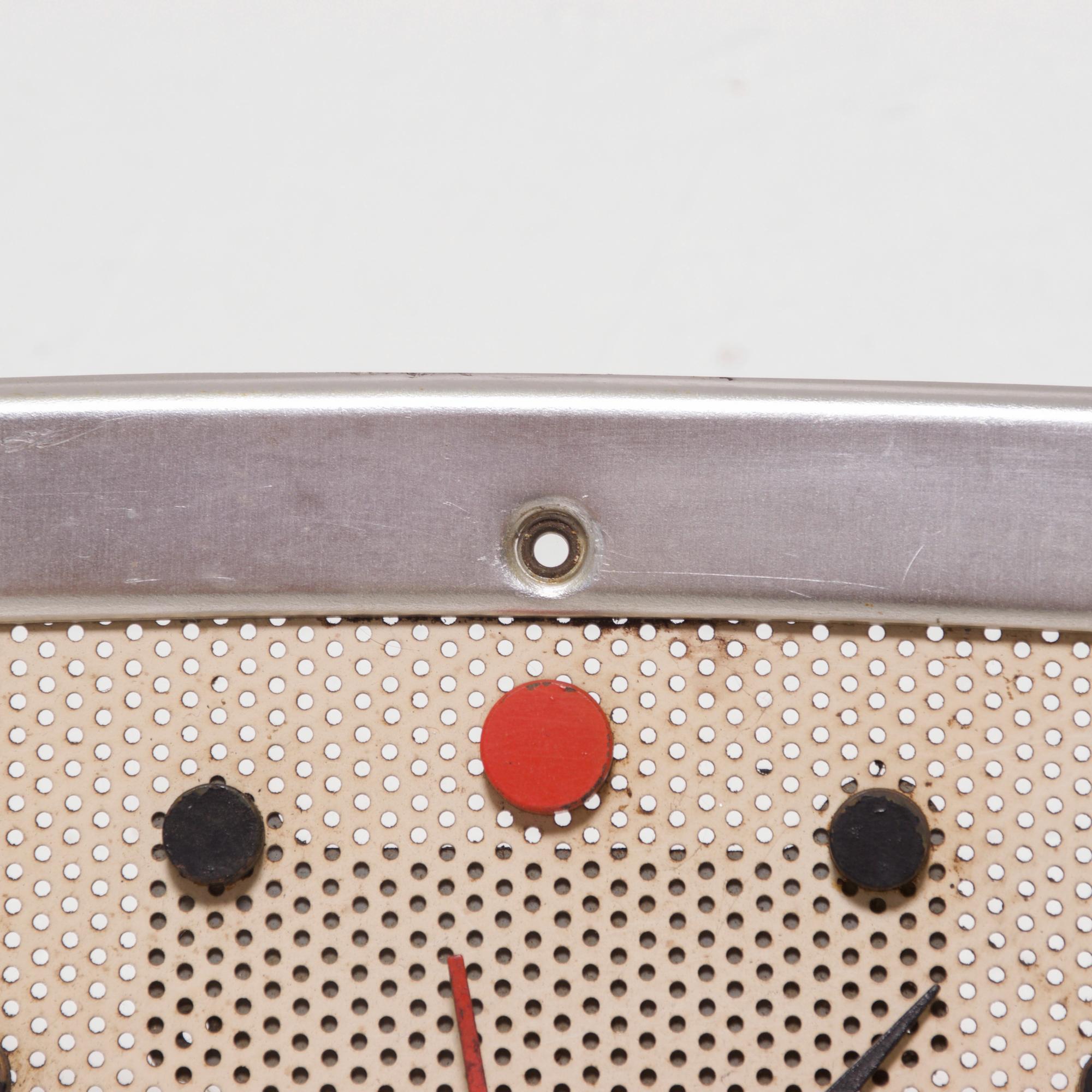 Vintage electric wall-mounted clock face by NuTone L-35 model Telechron chime clock, USA, circa 1957.
Style reminiscent of Herman Miller
Classic midcentury styling, face is white painted perforated metal was designed to allow sound to exit. Outer
