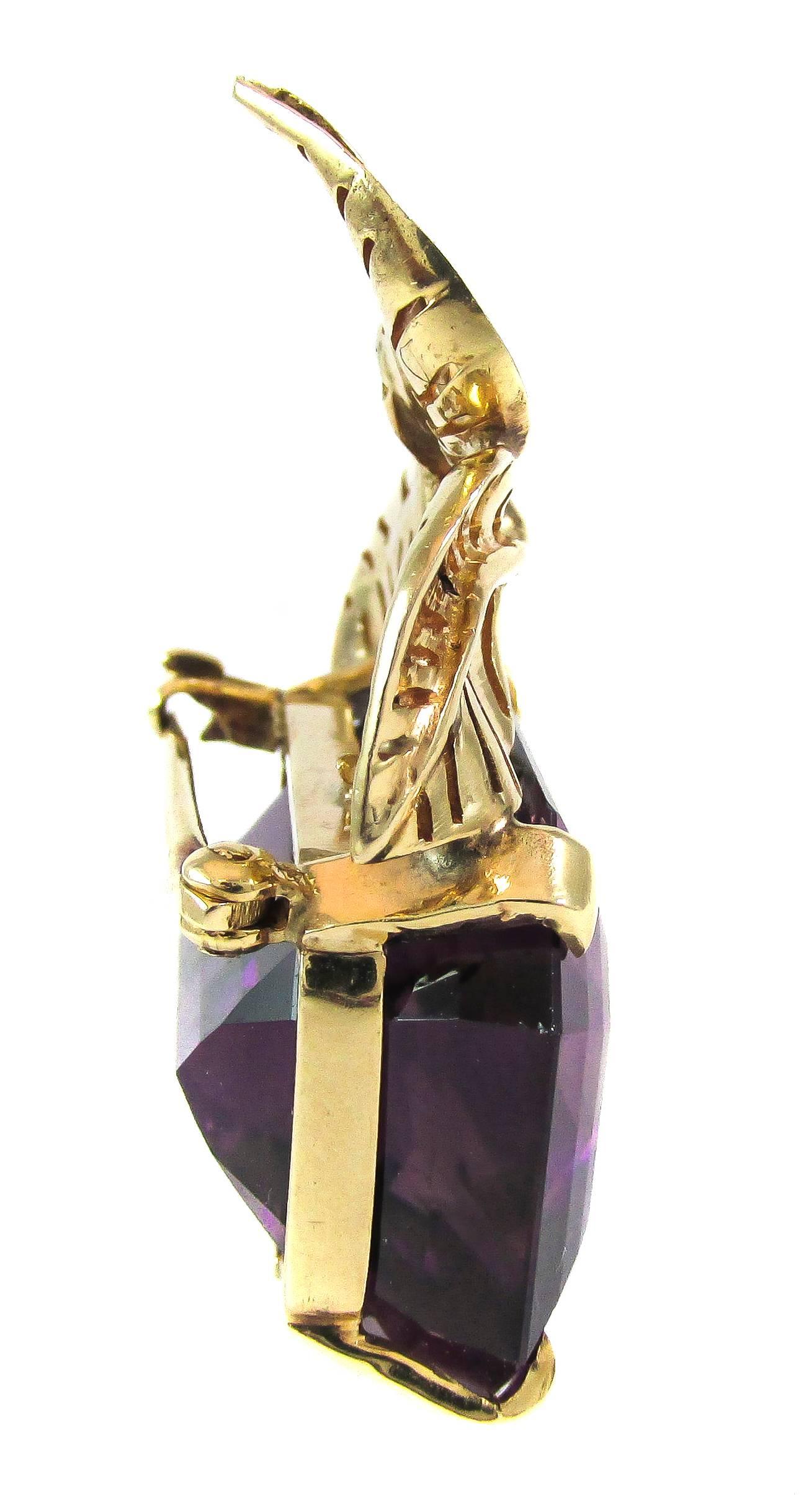 Rare Seaman Schepss 14 karat yellow gold brooch with excellent craftsmanship of leaf details at the top, set with a radiant deep purple emerald cut amethyst. This piece was specially commissioned by H.Stern in 1957 and is accompanies by the original