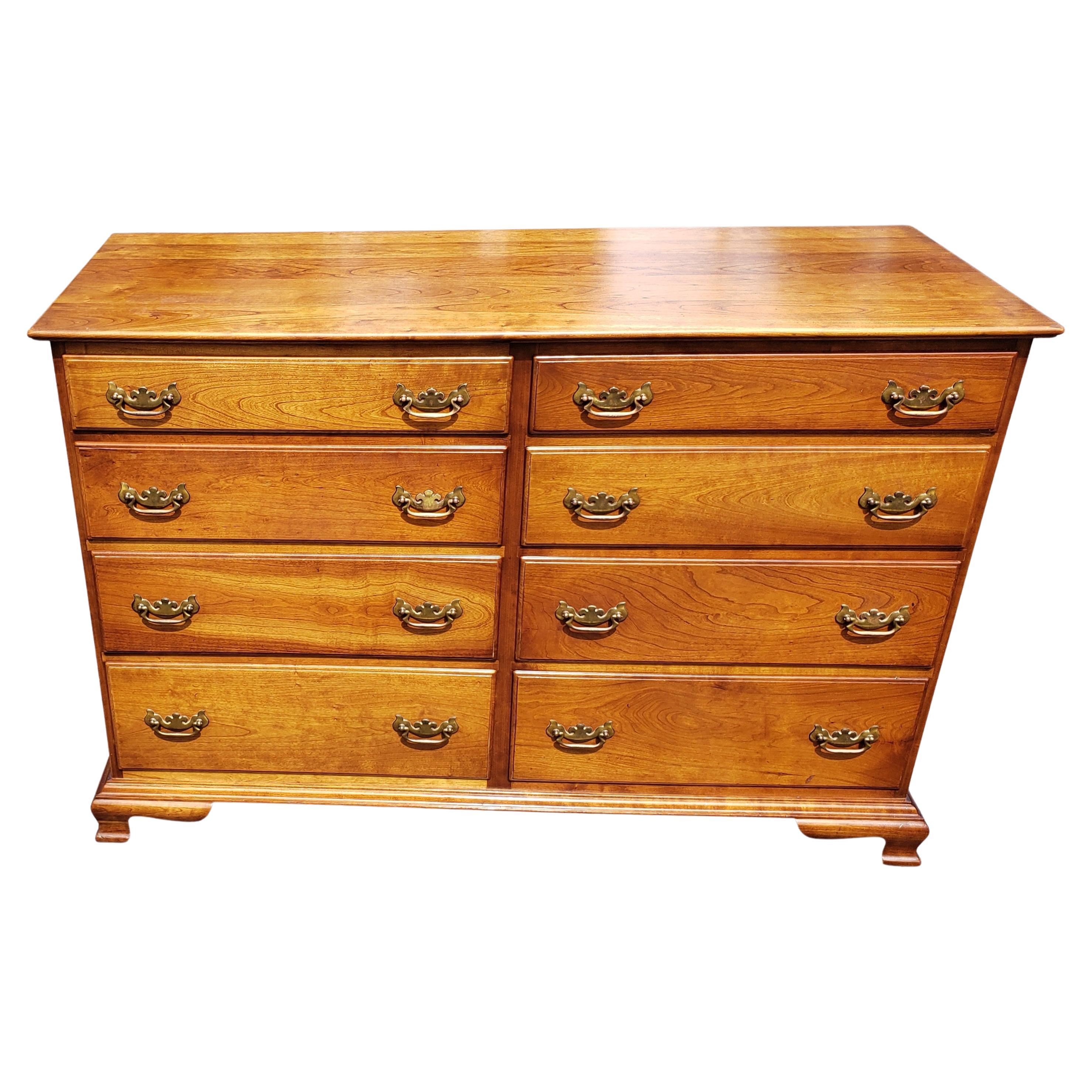 A 1957 eight drawer Cherry dresser by Stickley Furniture. Features eight drawers with pull handles made of brass. 
The front corners feature fluted columns. There is minor wear from use; Dresser is in good condition. 
Measures 52.5