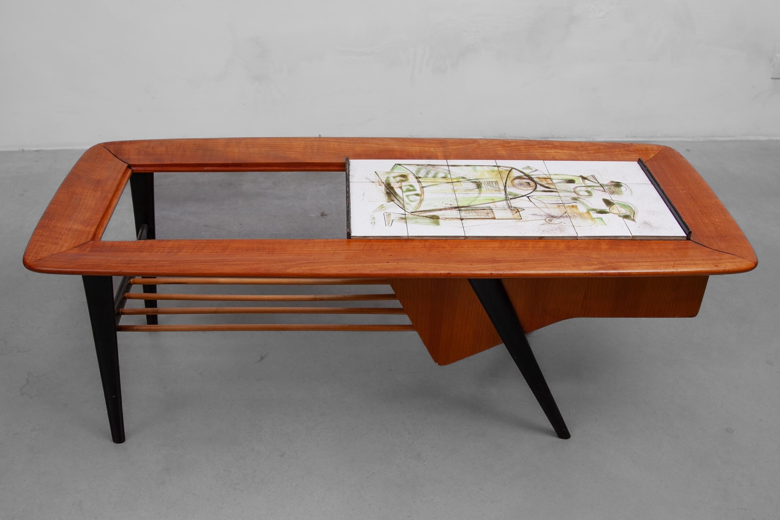 An iconic rare piece of furniture coffee, bar table designed in the end of the fifties by the Belgium Modern Architect Alfred Hendrickx for Belform. 
The table is made in a solid wood frame and part veneer, including an internal bar or magazine
