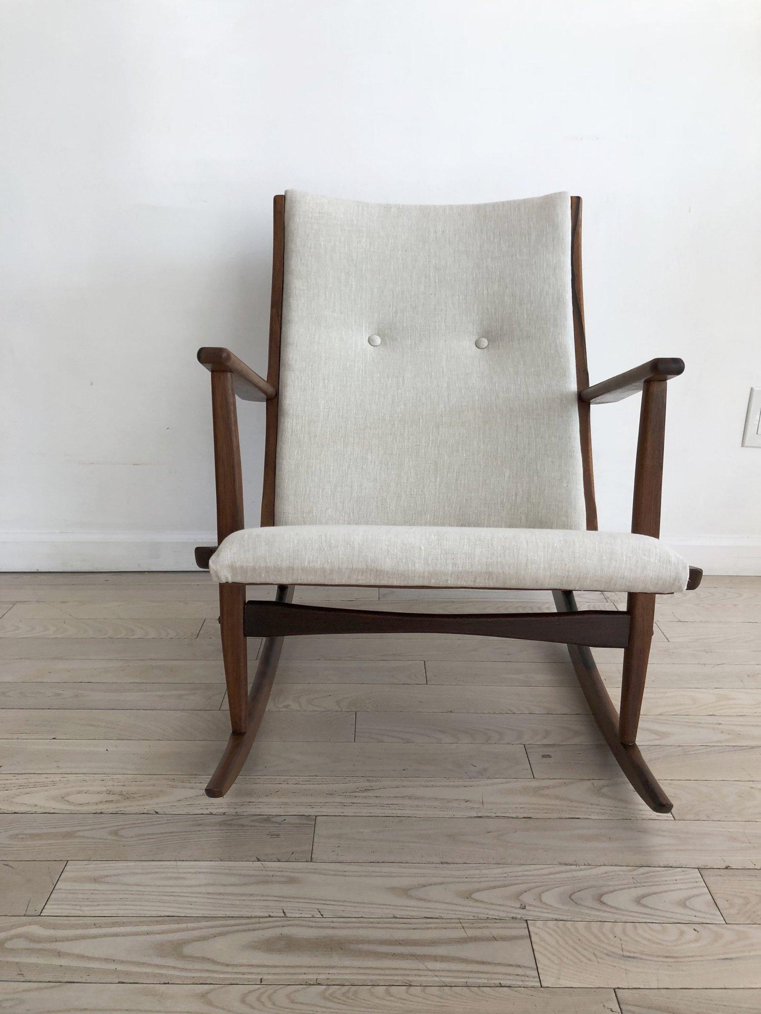 Wow, look at that rosewood! Amazing rosewood frame with new upholstery in soft grey linen. Superb petite rocker for your home. Made in Denmark designed by Holger George Jensen in 1958. Excellent condition. 

Measures: 25” wide x 29” tall x 30”