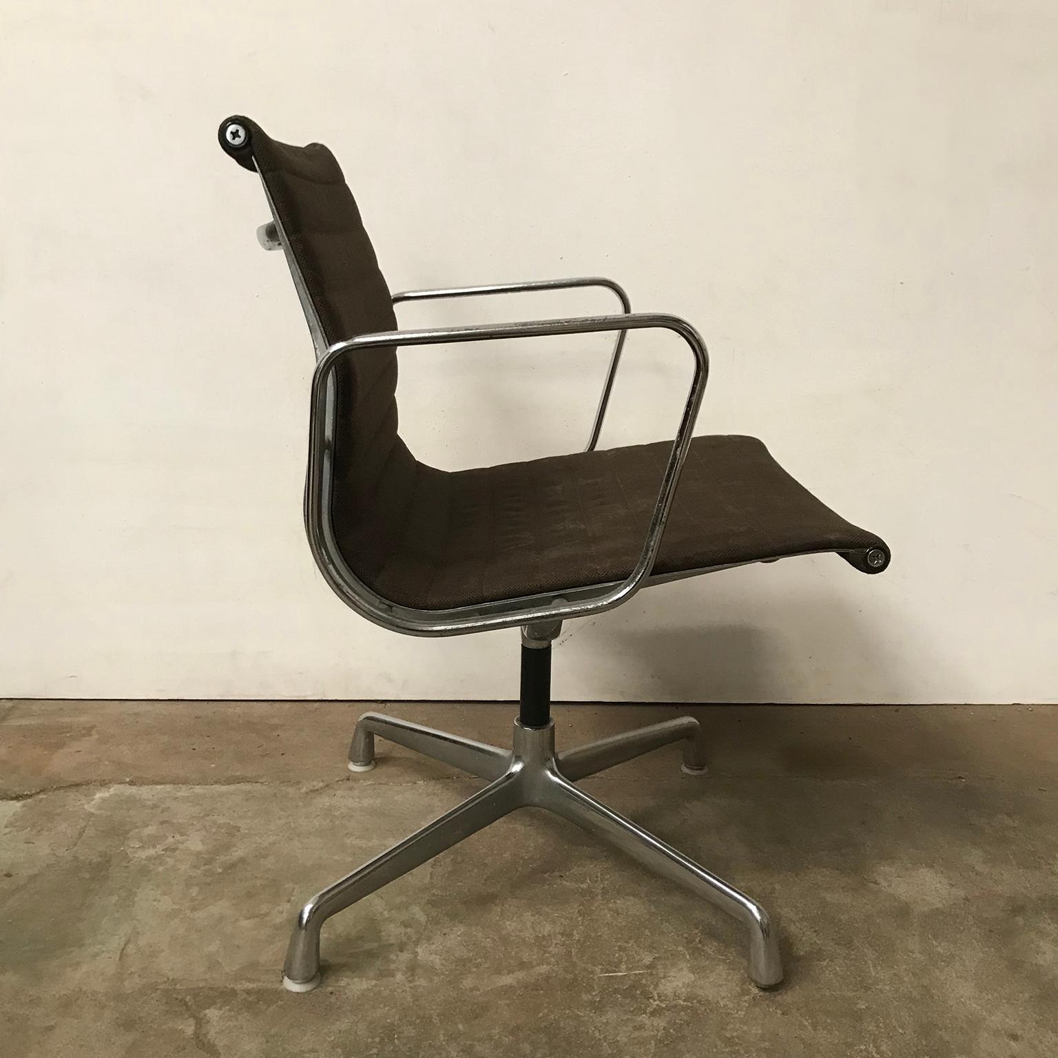 Brown EA 108 by Herman Miller with armrests and glossy base. The chair shows traces of wear like (moist) stains on the seat (pictures #7 - #10) and the base has some loss of chrome and some rusty spots (not rotating). Under the base is a brand and