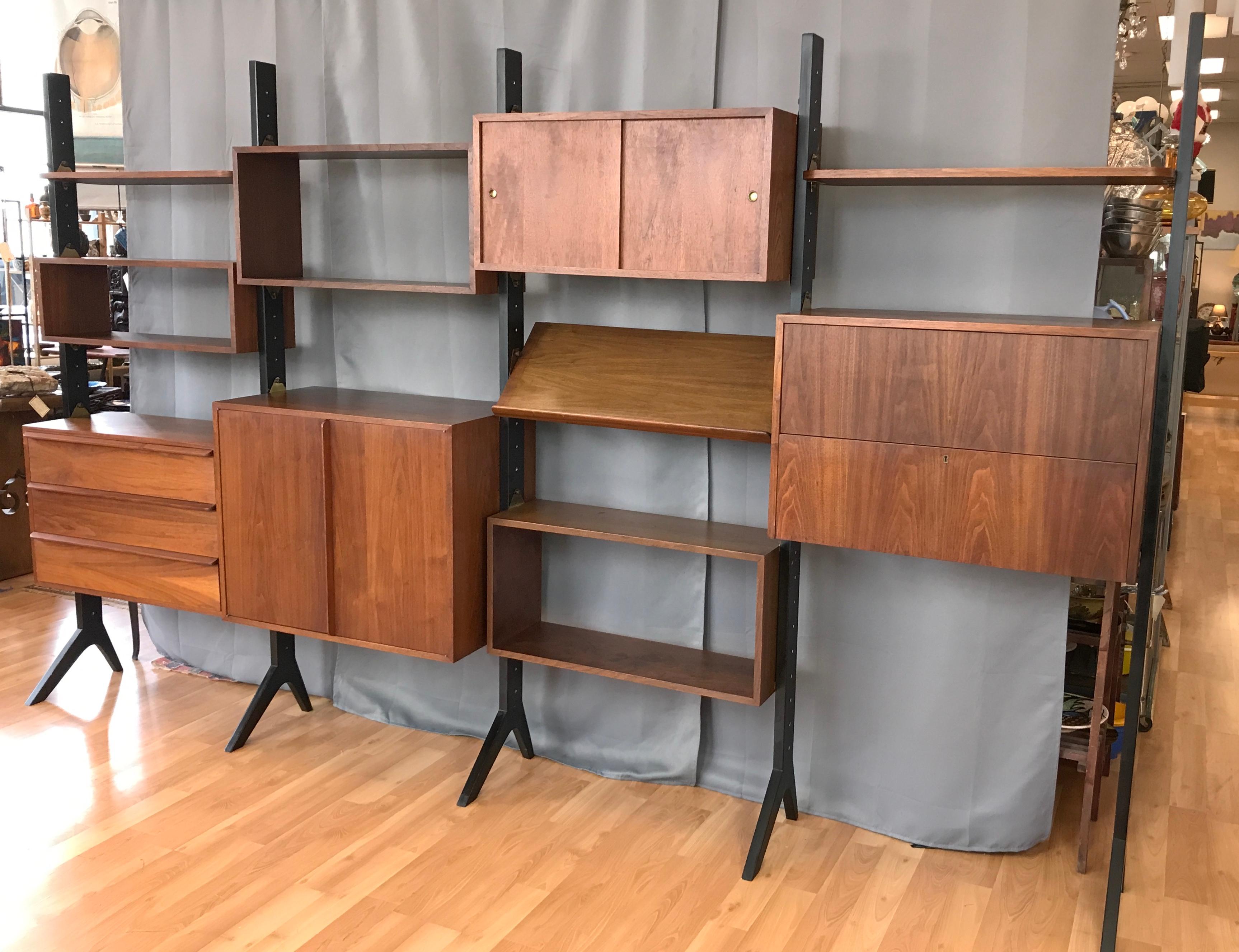 A fantastic looking, super functional, and rather rare mid-century modern Euro Art walnut freestanding four-bay modular storage system by Fritz of California.

Similar in style to both the wall-mounted Omni System by George Nelson and the Royal
