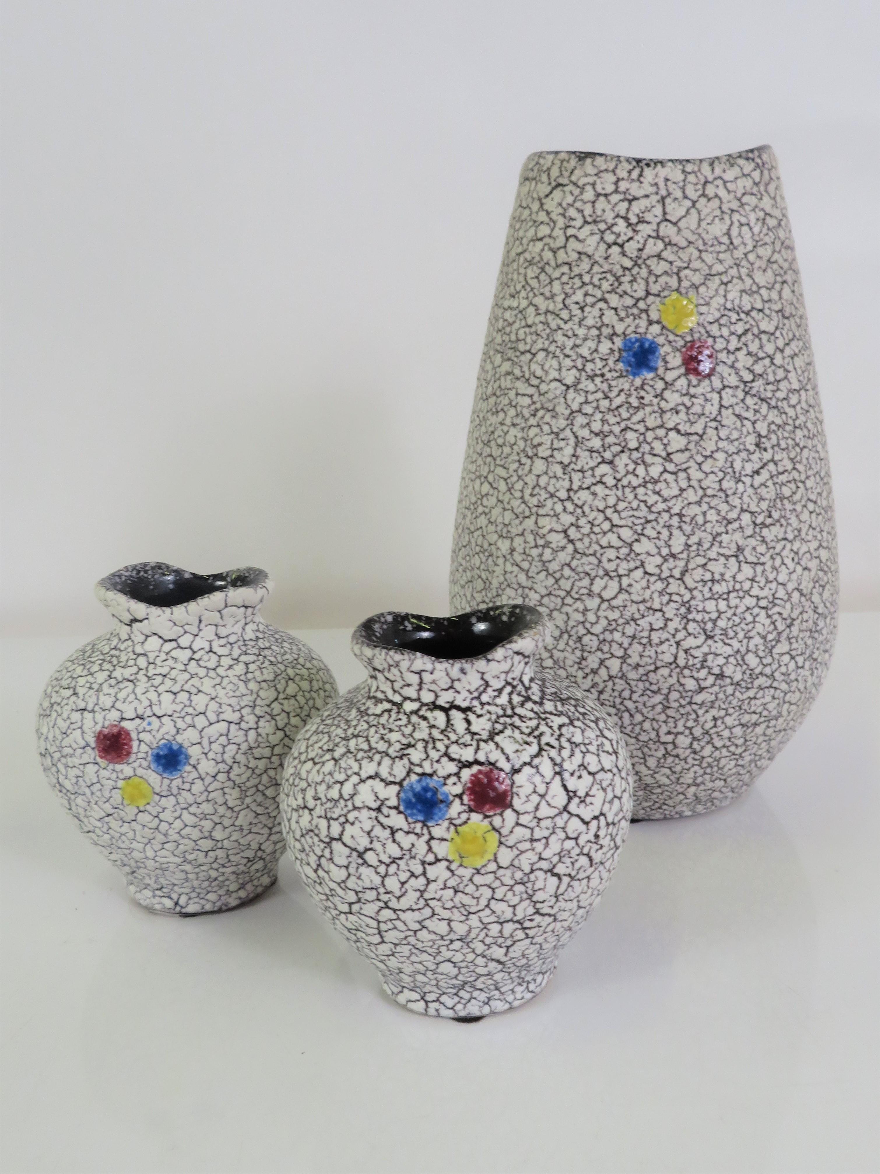 Great Modern 1958 set of 3 Mid Century Jopeko Keramik crinckled Lava glaze ceramic pieces, consisting of one large vase and a pair of smaller complimentary vases. All covered in a white crinkled lava glaze on a dark brown background with a