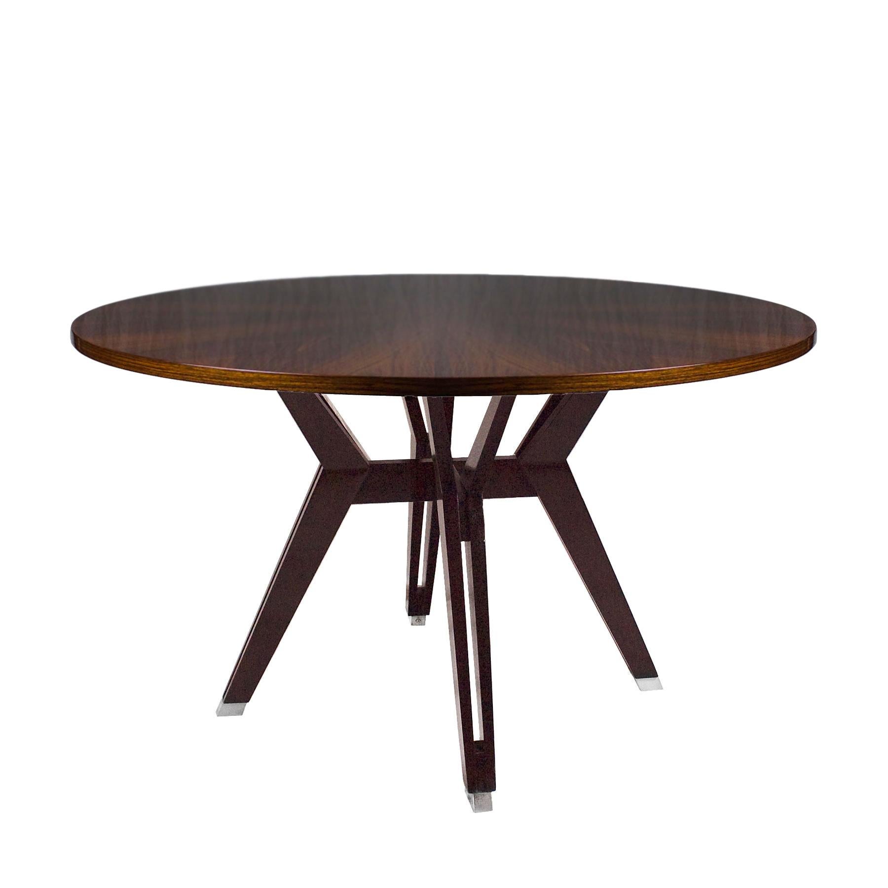Round table with solid walnut openwork four doble stands connected by a strut, nickel plated metal hardware, top with star shape mahogany palm veneer, French polish.
Design: Ico Parisi.
Maker: M.I.M. Roma (label)

Italy 1958.