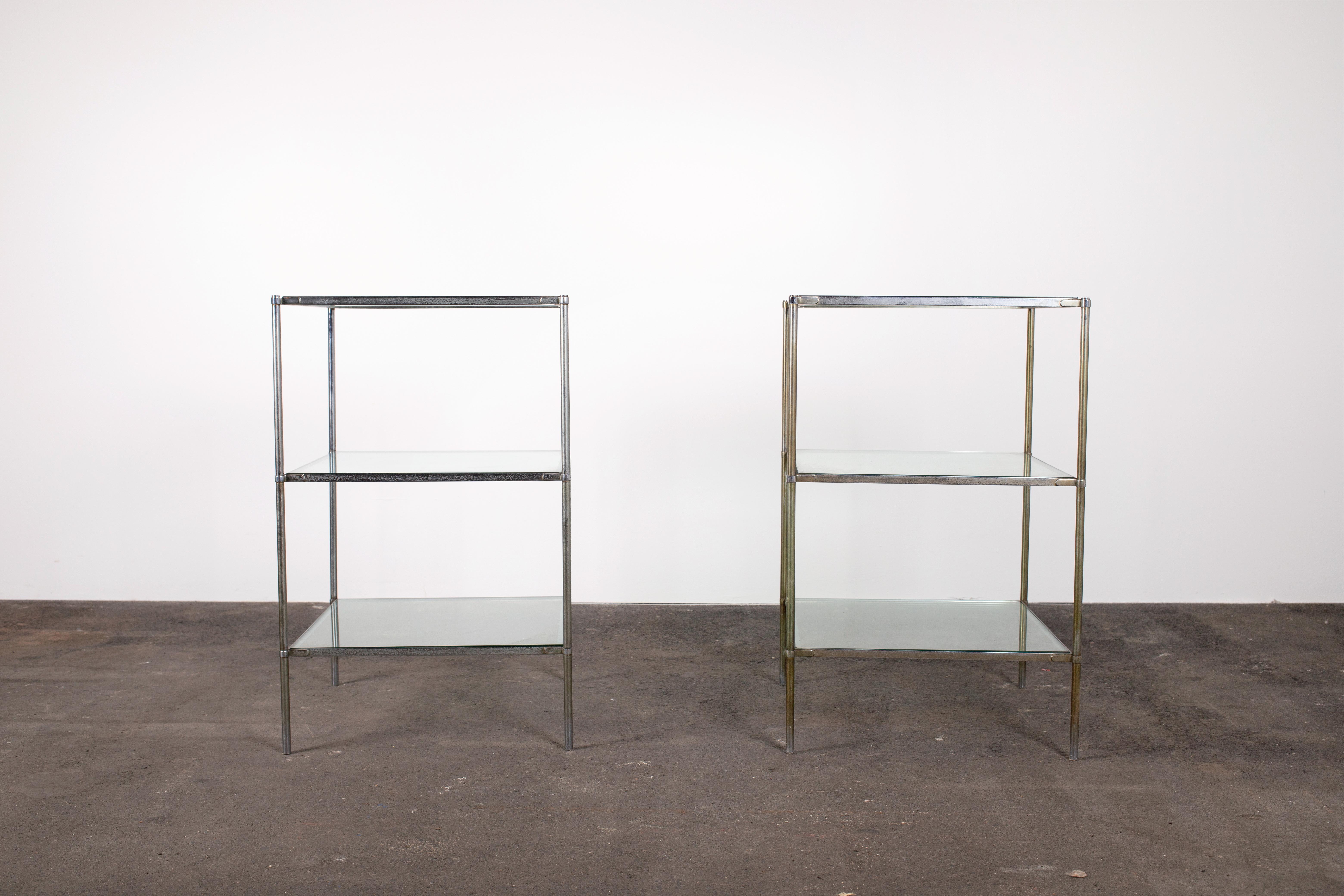 Sleek, minimalist Mid-Century Modern pair of console tables by Corrado Corradi Dellácqua for Azucena in thick crystal and sculpted chrome. 

Each table is constructed of four thin cylindrical steel columns with three plates of thick square crystal
