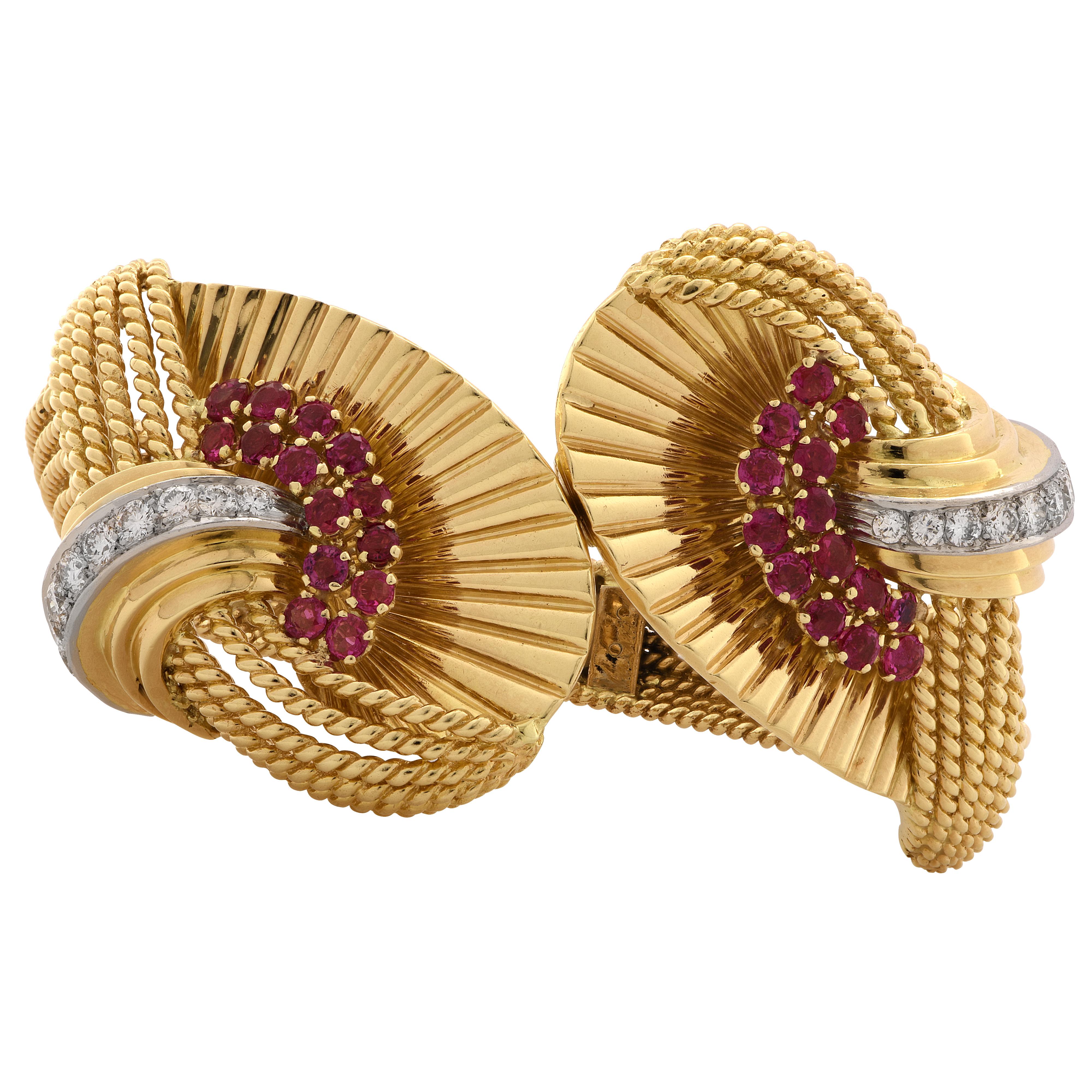 Spectacular Kutchinsky 18 Karat yellow gold retro bangle crafted in London, England in 1959, showcasing 20 round brilliant cut diamonds weighing approximately 2.50 carats, F color, VS clarity, further accented by 28 round cut Rubies weighing