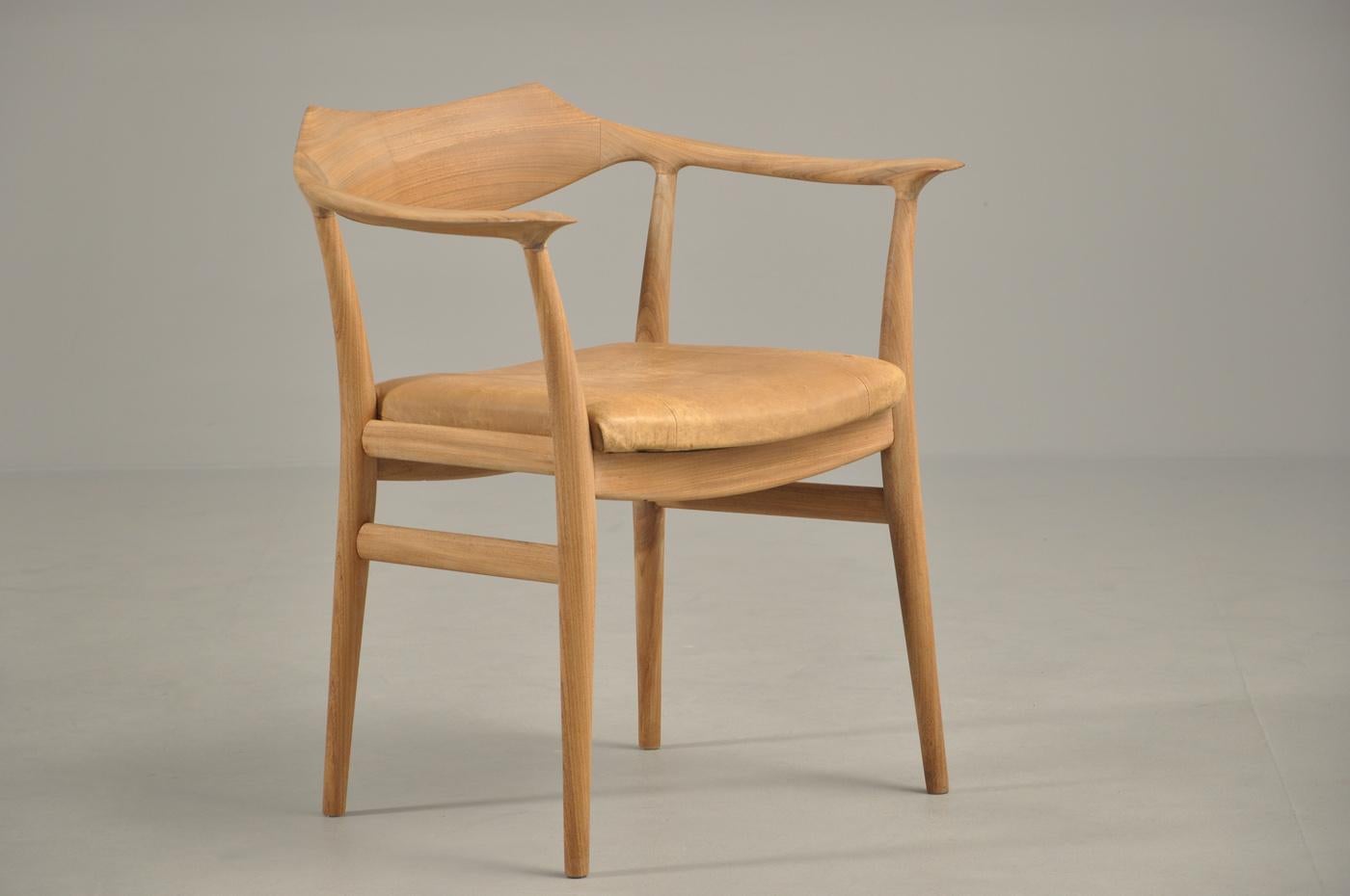 1959 Sigurd Ressell Fauteuil en teck massif, assise recouverte de cuir naturel. Fabriqué par l'ébéniste Niels Vodder. Modèle SR59, conçu en 1959 et présenté lors de la 33e exposition de la Guild à Copenhague en 1959. Hauteur : 28.75 in (73.03 cm)