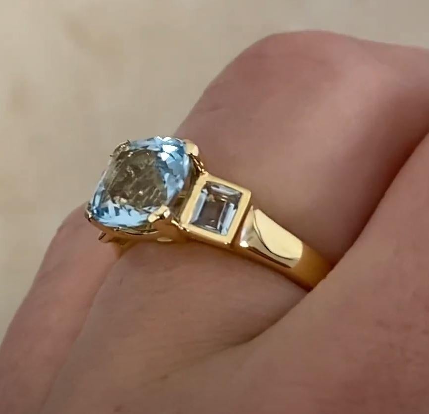 This exquisite ring showcases a stunning cushion-cut aquamarine at its center, prong-set to highlight its brilliance. The captivating gemstone weighs approximately 1.90-carats, displaying a mesmerizing blue hue that catches the light beautifully.