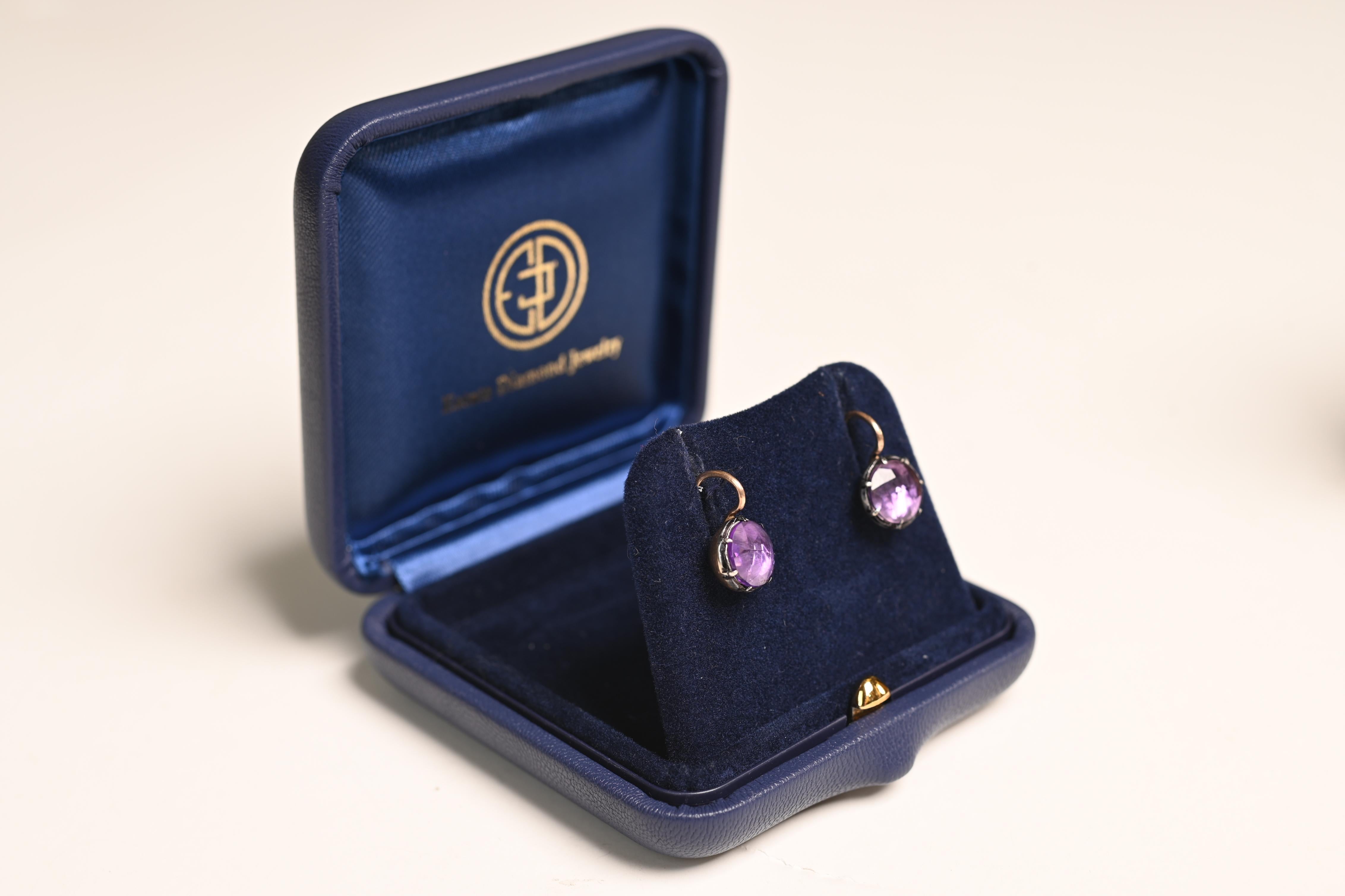 This exquisite pair of antique-style gemstone earrings showcases a stunning duo of rose-cut amethysts, collectively weighing a 2.57 grams. Each gemstone is carefully selected for its rich, violet hue and delicate translucence, enhancing its natural