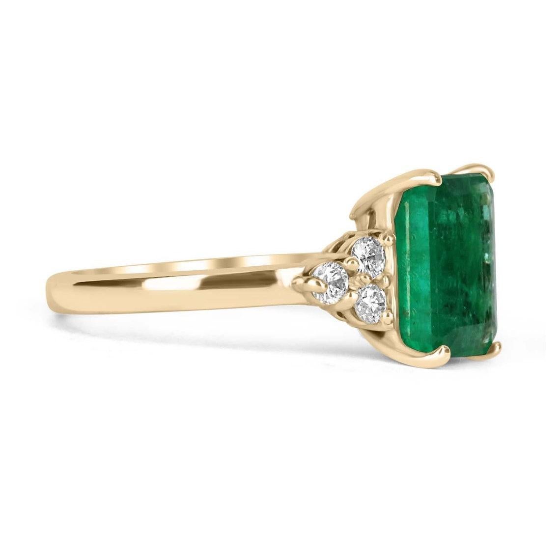 An emerald cut, emerald and diamond 14K ring. Dexterously handcrafted in gleaming solid 14K yellow gold, this ring features a natural emerald, set in a secure four-prong setting. This extraordinary emerald has stunning green color, strong