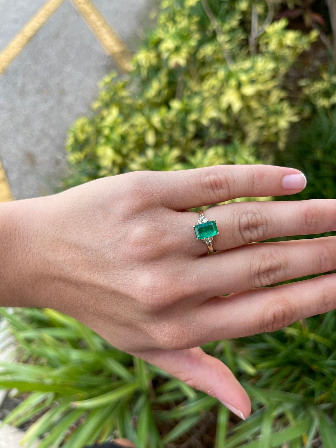 diamond ring with emerald accents