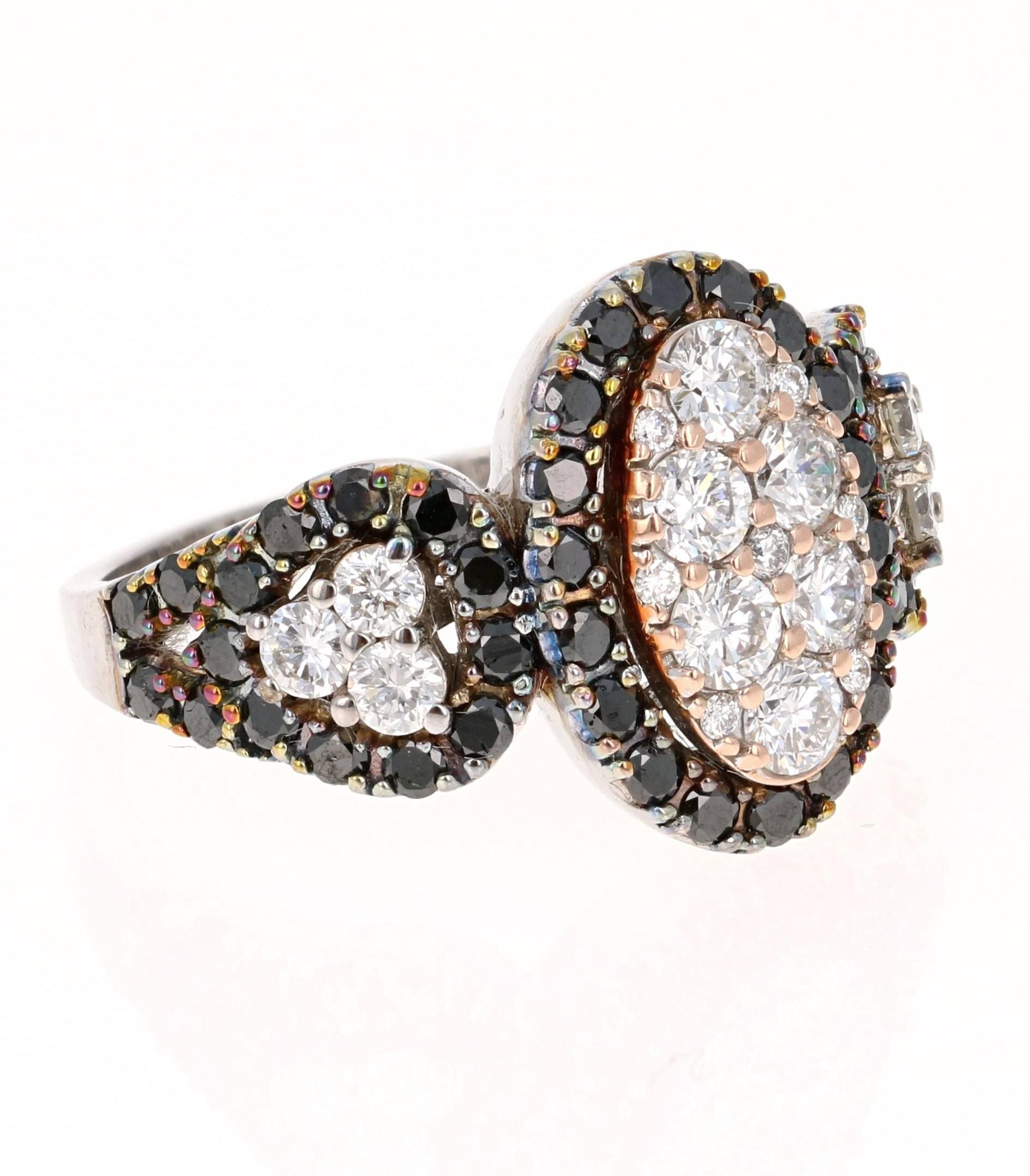 This stunning cluster ring has the look of huge 3-stone ring.   It has 19 Round Cut Diamonds that weigh 0.98 carats (Clarity: VS2, Color: F) and is surrounded by 49 Round Cut Black Diamonds that also weigh 0.98 carats.  The total carat weight of