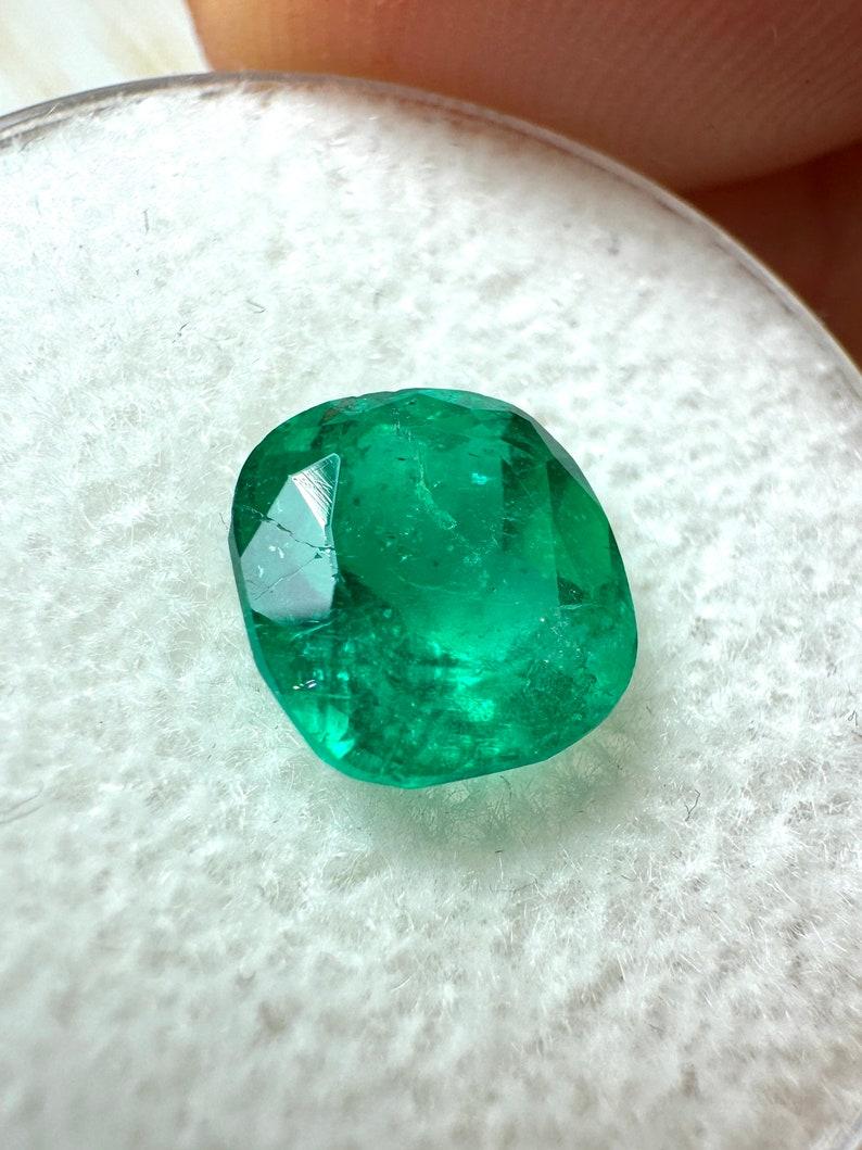 Stone: Emerald
Weight: 1.96-carats
Shape: Cushion Cut
Clarity: Transparent
Luster: Very Good
Color: Medium Green
Measurements: 7.88mm x 7.40mm x 5.51mm
Geographic Origin: Colombia
Treatment: Natural, Moderate to Significant Oil

This emerald has