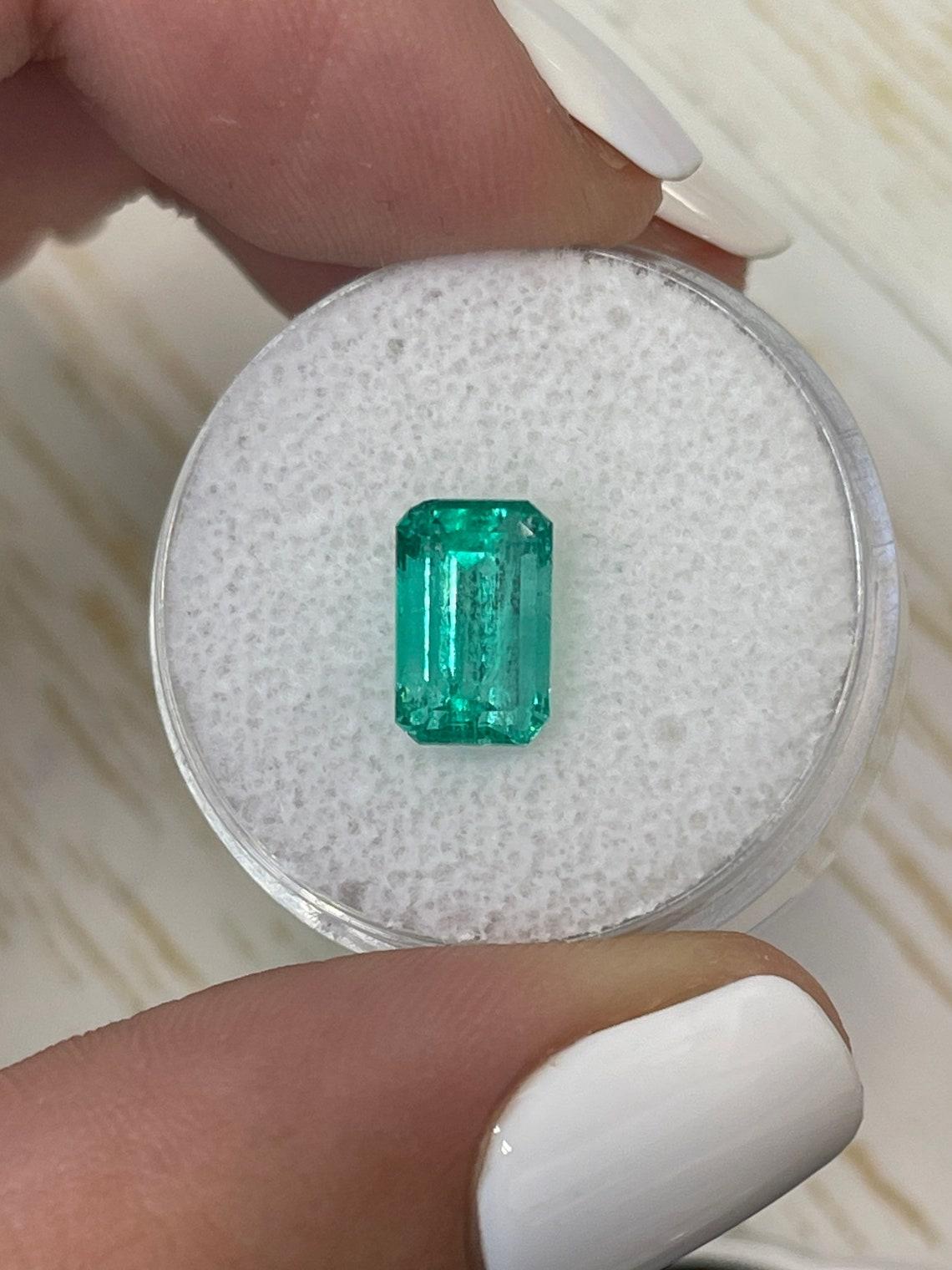 Stone: Emerald
Weight: 1.96-carats
Shape: Emerald Cut
Clarity: Transparent
Luster: Very Good
Color: Bluish Green
Measurements: 9.33mm x 5.93mm x 4.92mm
Geographic Origin: Colombia
Treatment: Natural, Oiling

Comments: Due to their growth conditions