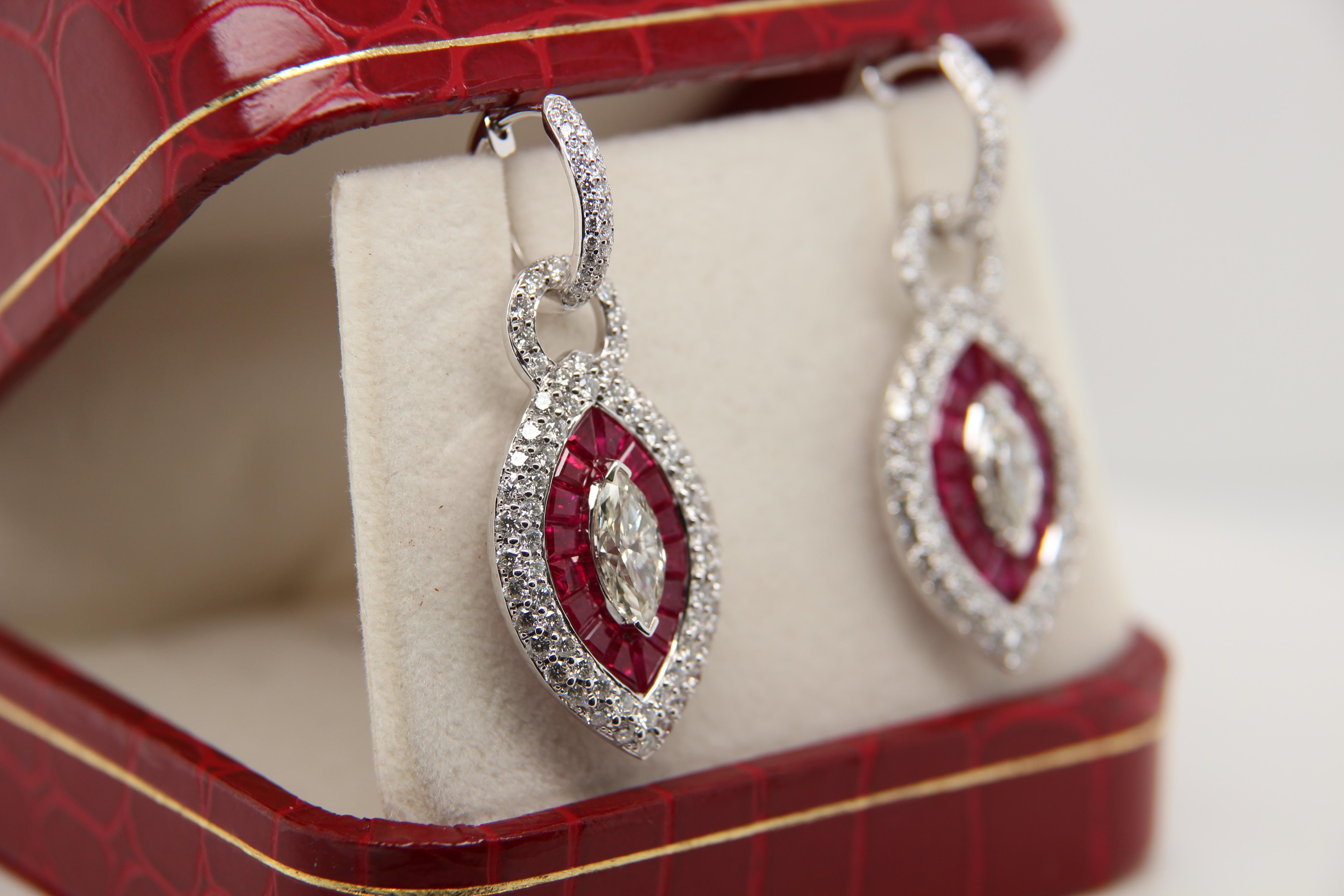 A diamond and ruby earring. The center marquise diamond pair weighs 1.96 carat totally and surrounded by 3.30 carat rubies and 2.49 carat diamonds. It is made in 18 karat white gold 12.76 g gross weight.