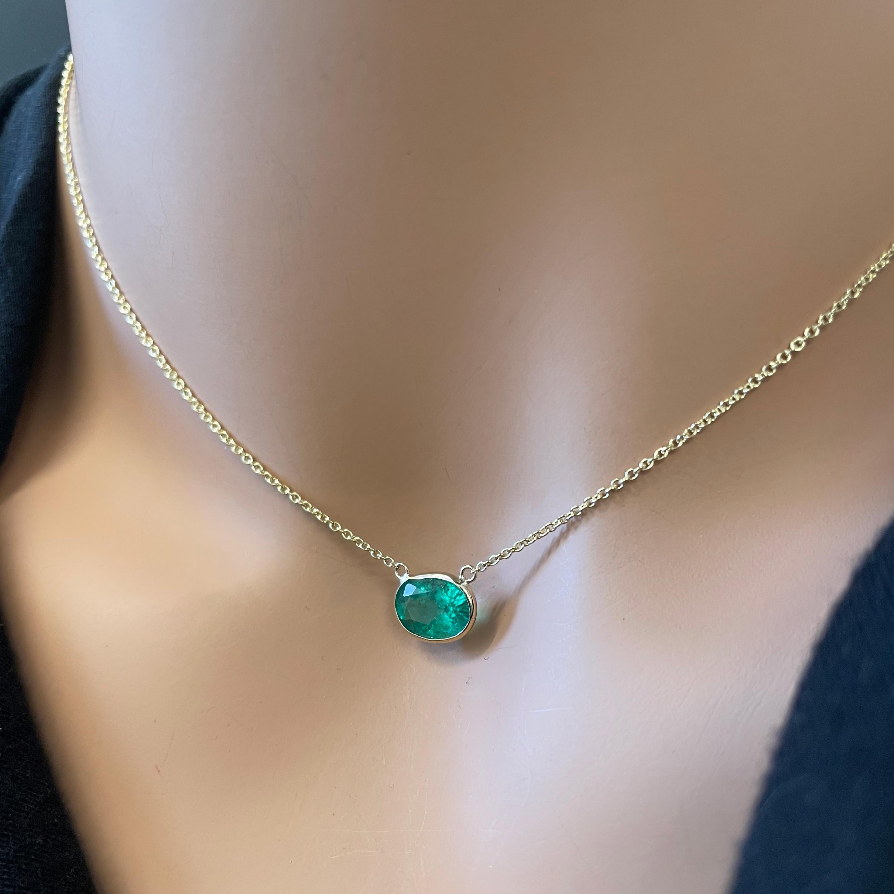 This necklace features an oval-cut green emerald with a weight of 1.96 carats, set in 14k yellow gold (YG). Emeralds are highly prized for their vibrant green color, and the oval cut is a classic and elegant choice for gemstones, offering a timeless