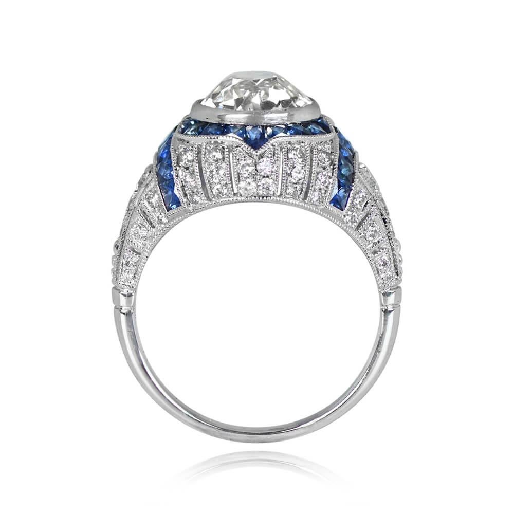 Art Deco style ring w/ 1.96ct old European cut diamond (K, VS1). French cut sapphires in geometric halo and on shoulders. Round brilliant cut diamonds in vertical rows along mounting. Total diamond weight: 0.52ct. Total sapphire weight: 1.06ct.