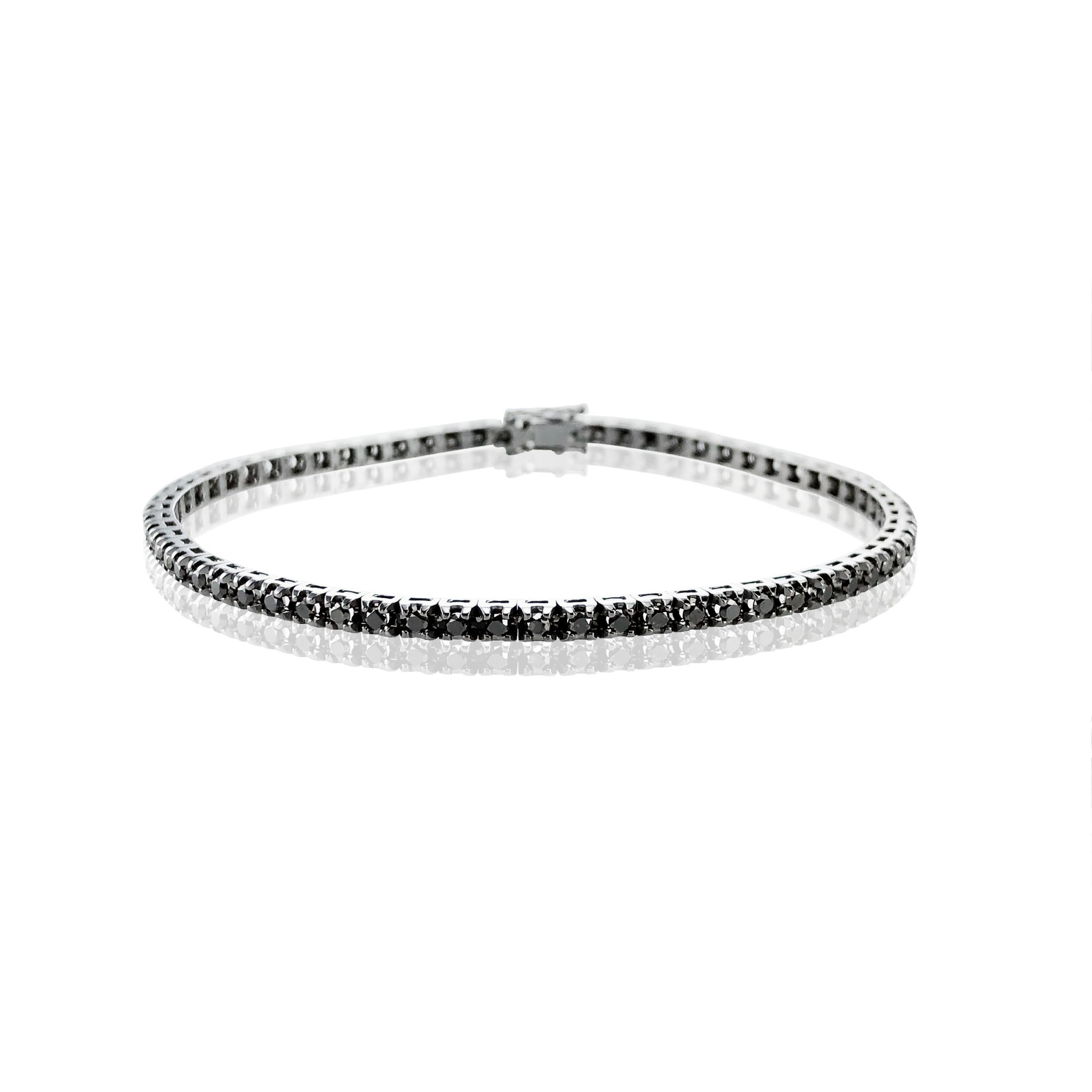 This fabulously stylish Black Diamond 1.96 Carat Unisex Tennis Bracelet, is wearable on any wrist. 

Set in 18kt white Gold and secured with an open box clasp, water proof it can remain on the wrist continually.

Worn alone or stacked with other