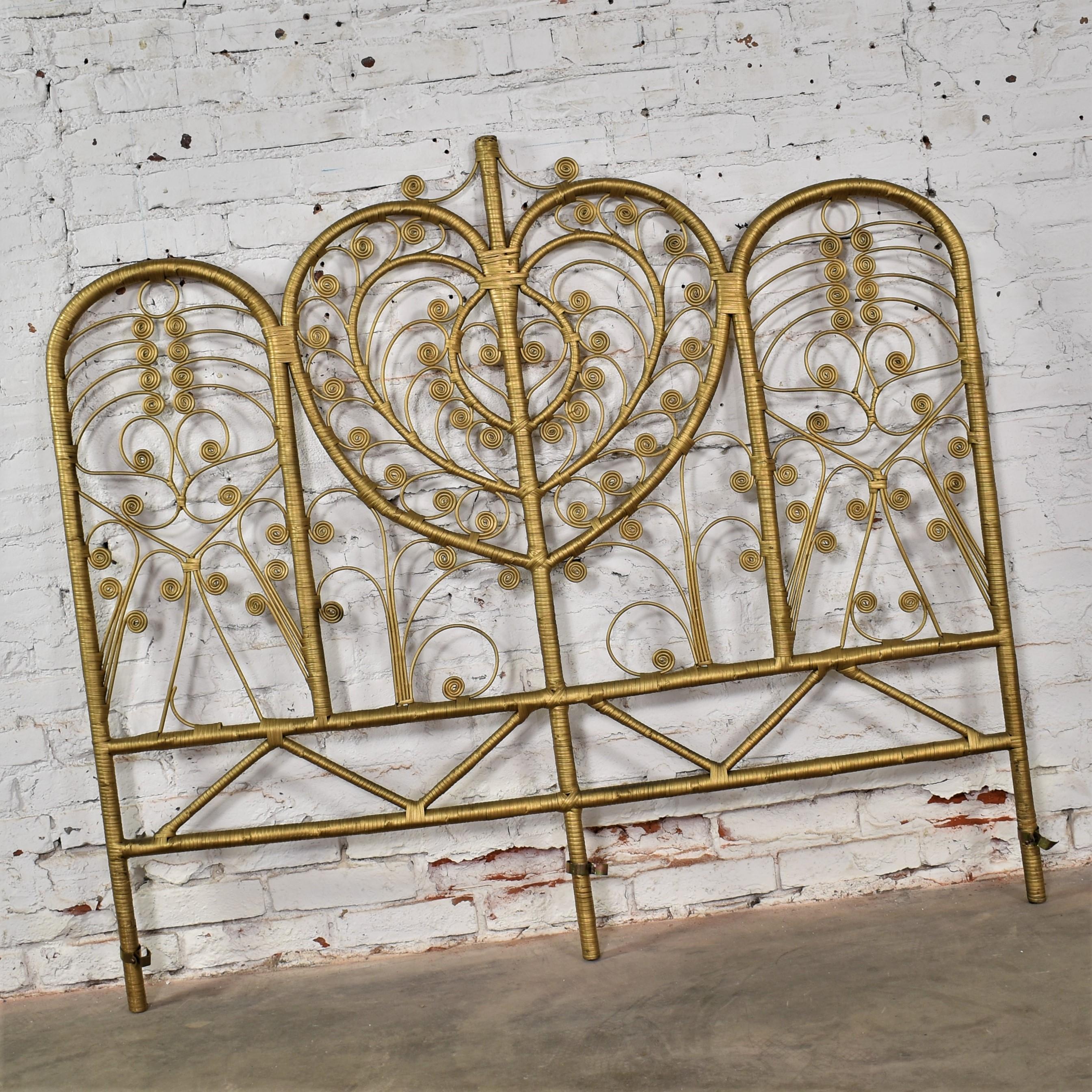Stunning vintage Hollywood Regency Bohemian gold painted wicker full sized headboard with a heart center shield, side arches, spirals, and scrolls. Beautiful condition, keeping in mind that this is vintage and not new so will have signs of use and