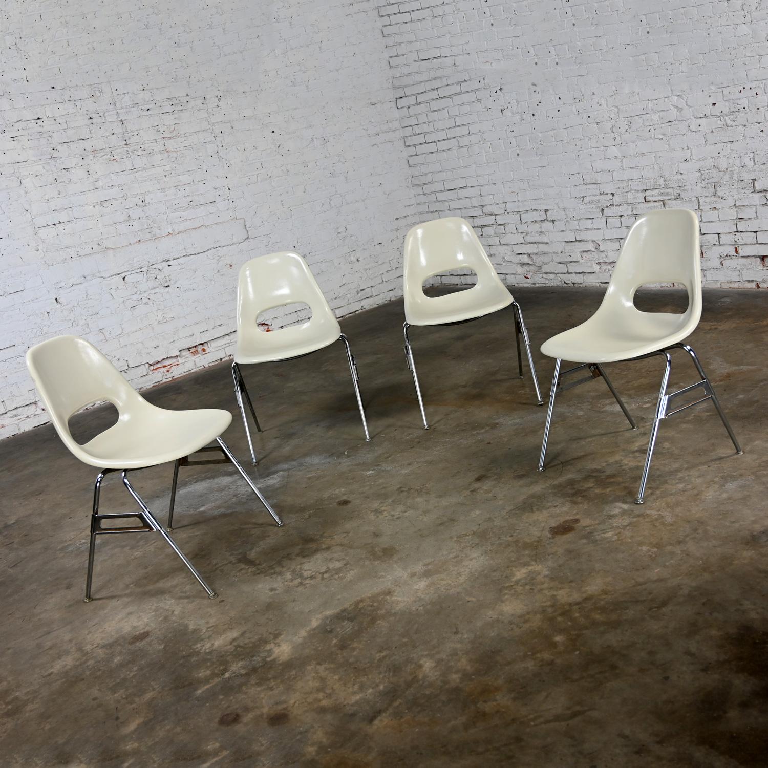 Handsome vintage Mid-Century Modern Krueger International white molded fiberglass shells & chrome tube base stacking chairs, set of 4. Beautiful condition, keeping in mind that these are vintage and not new so will have signs of use and wear even if