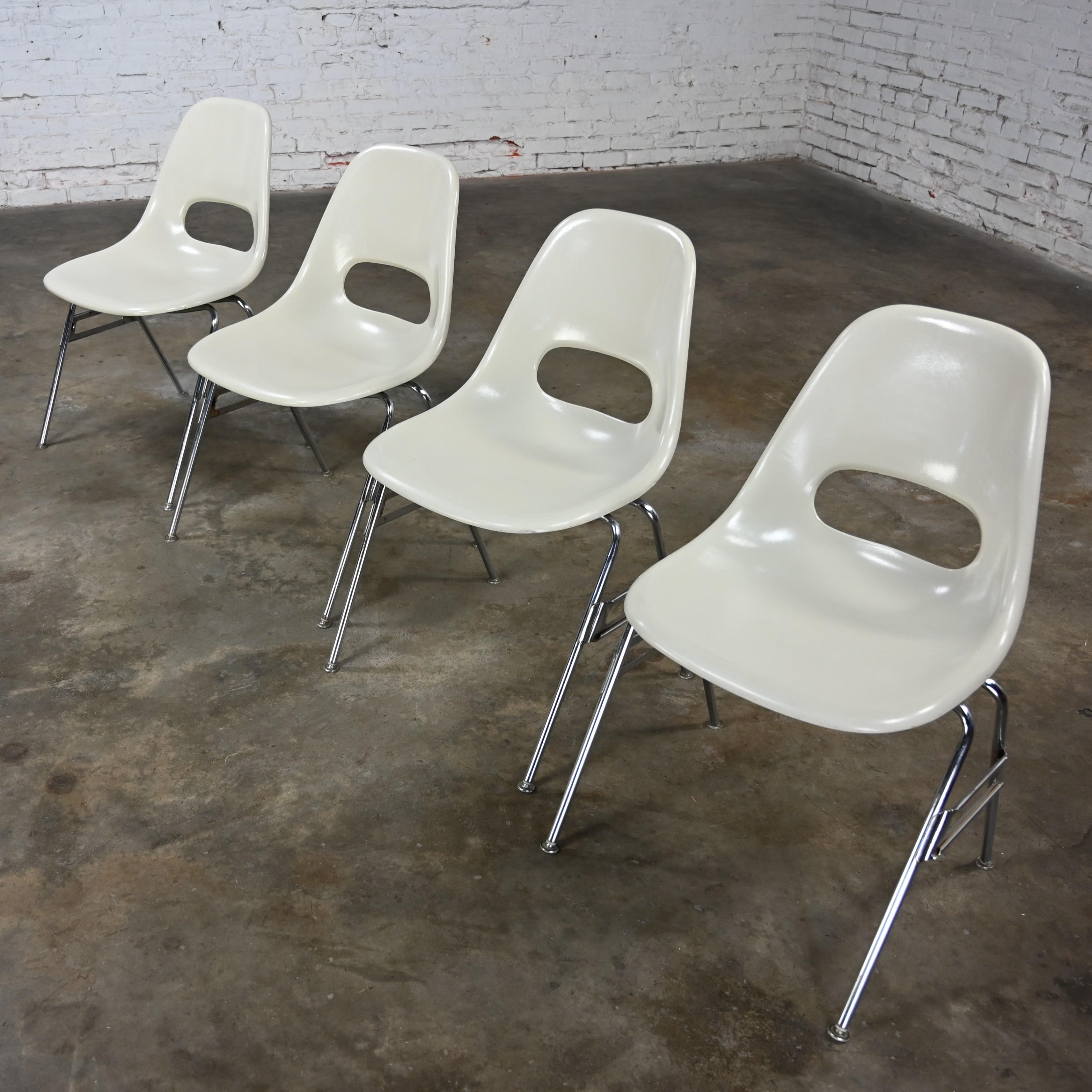 Handsome vintage Mid-Century Modern Krueger International white molded fiberglass shells & chrome tube base stacking chairs, set of 4. Beautiful condition, keeping in mind that these are vintage and not new so will have signs of use and wear even if