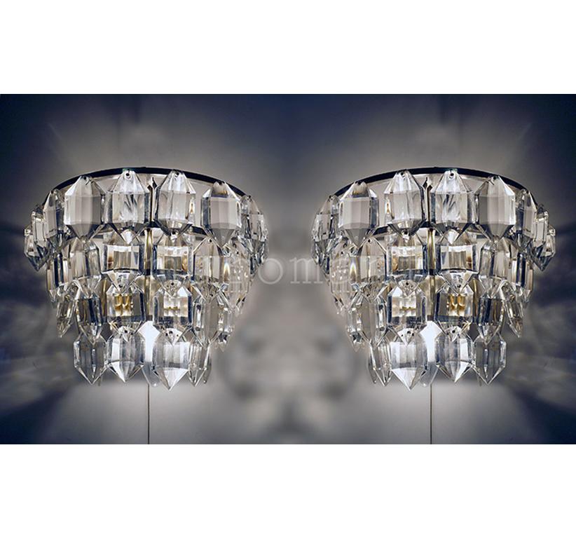 Elegant sconces with faceted crystals on 4 tiers mounted on silver-plated wall frame. High quality workmanship. Made for eternity. 

Manufactured by Bakalowits & Sons, Vienna, Austria in the 1960s. 
 
Measures: width 9.9