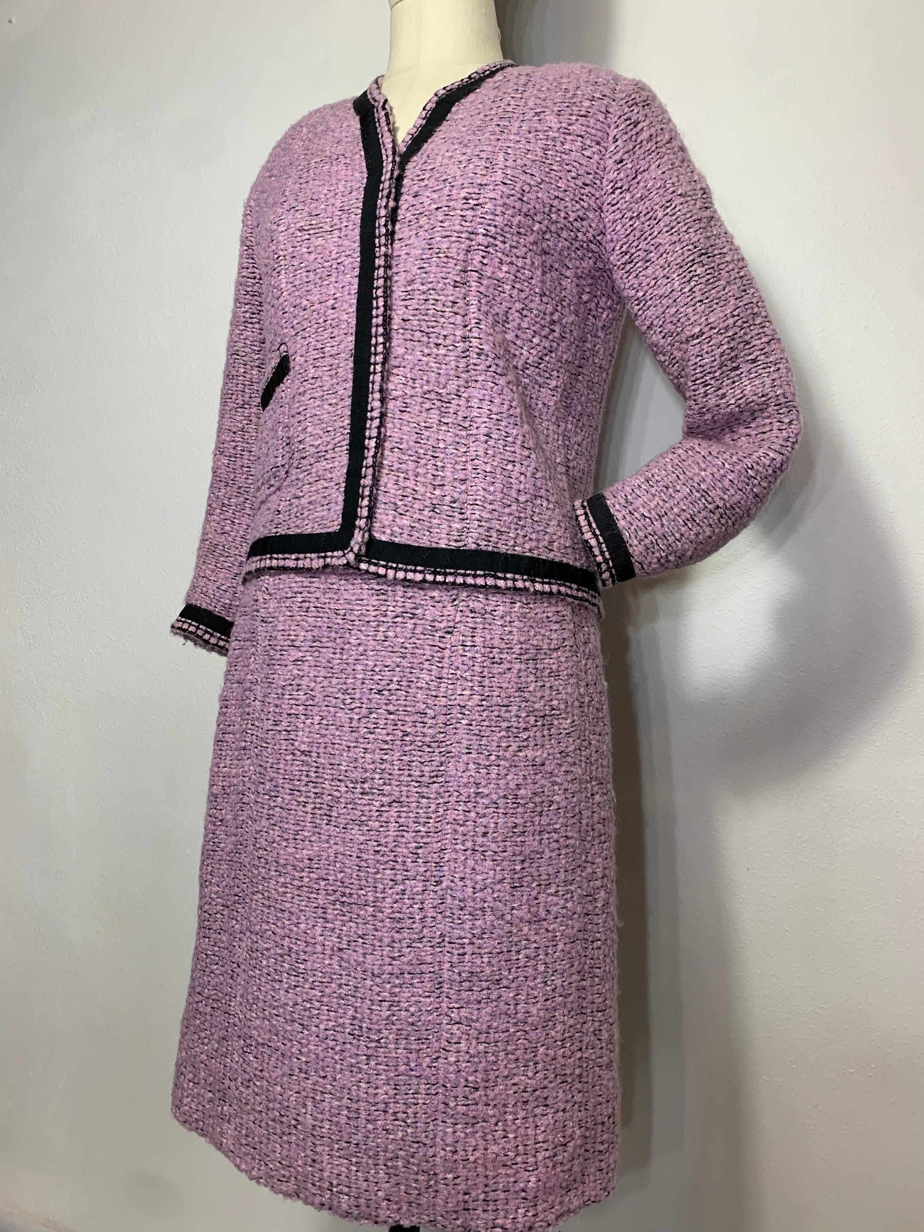 1960 Autumn/Winter Chanel Haute Couture Documented Lavender Tweed Skirt Suit: This breathtaking 2 piece haute couture suit designed by the one and only Gabrielle Chanel is made of a lavender wool tweed boucle with black grosgrain trim. A relaxed