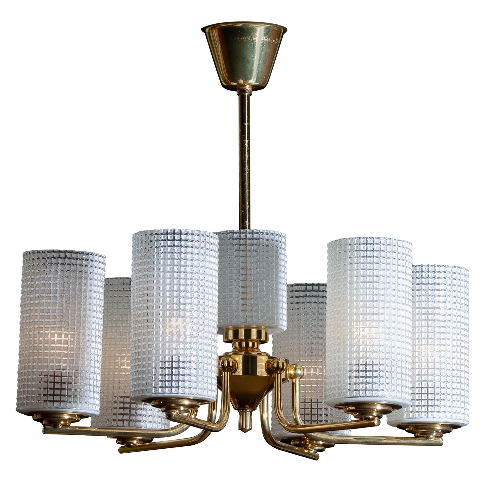 1960s, beautiful and excellent brass chandelier designed by Carl Fagerlund for Orrefors, Sweden.
The six glass vases are 18cm / 7 inch high. The one in the middle is 11cm / 4.3 inch.
The overall condition is very good.
  