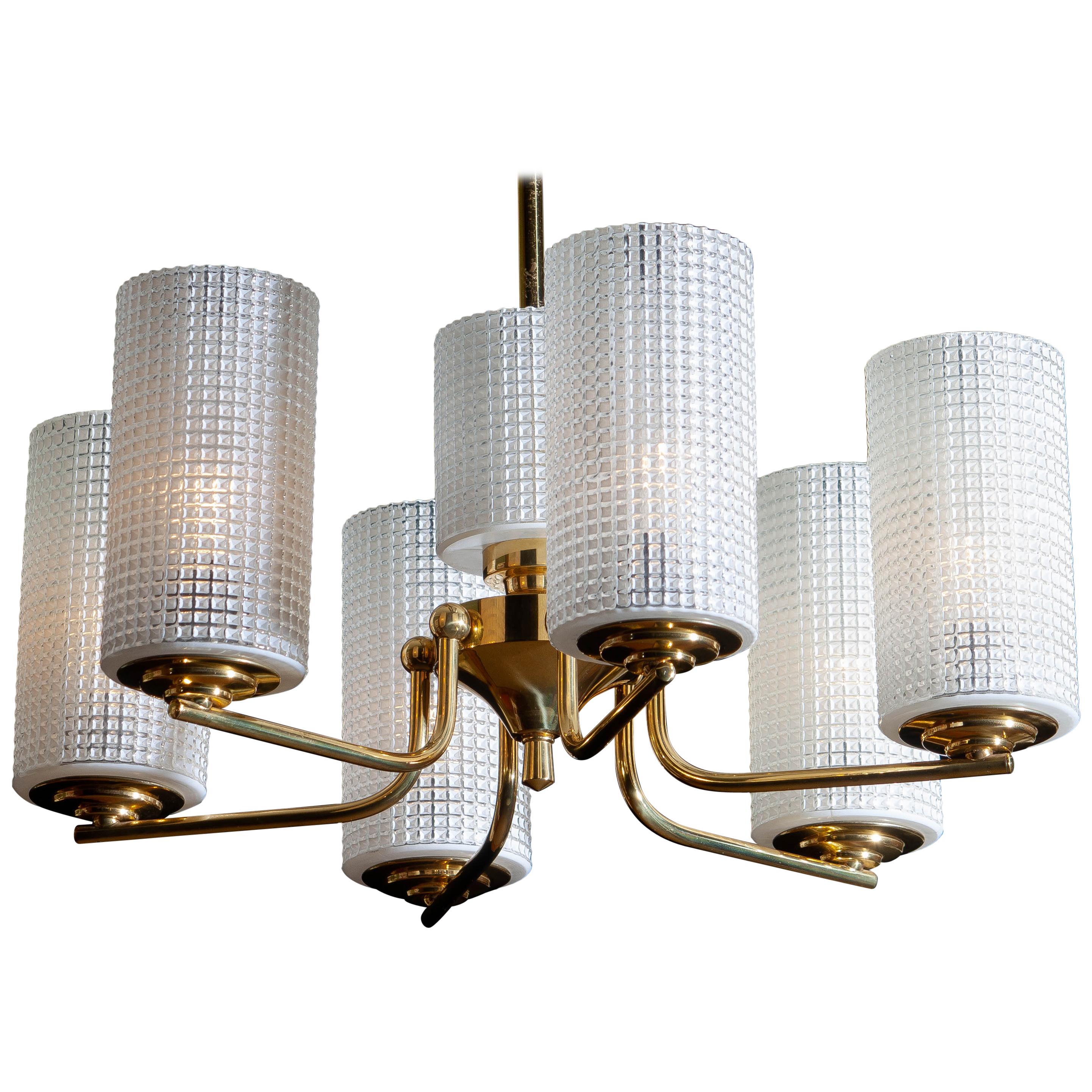 1960s, beautiful and excellent brass chandelier designed by Carl Fagerlund for Orrefors, Sweden.
The six glass vases are 18cm / 7 inch high. The one in the middle is 11cm / 4.3 inch.
The overall condition is very good.
         