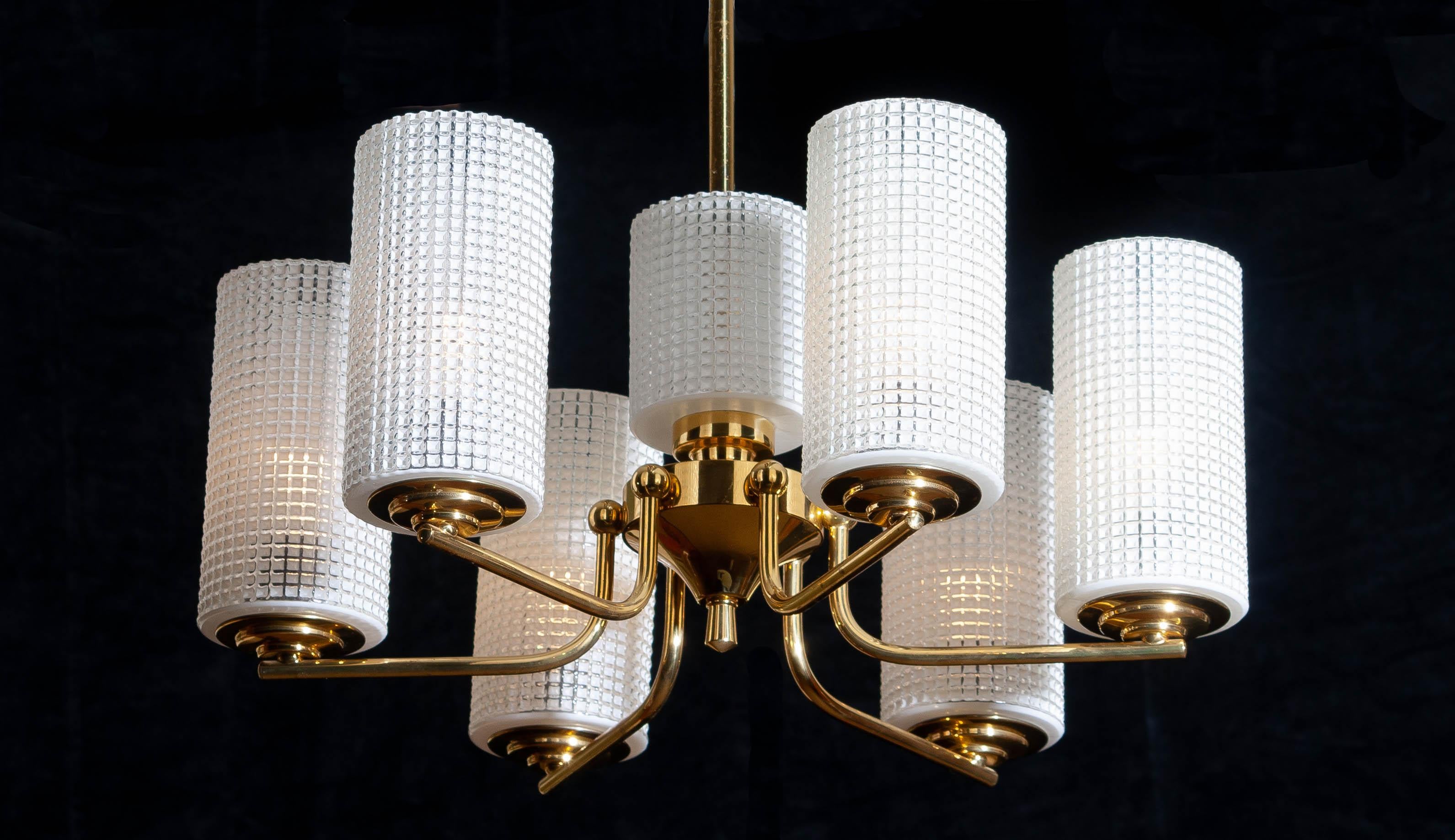 1960s, beautiful and excellent brass chandelier designed by Carl Fagerlund for Orrefors, Sweden.
The six glass vases are 18cm / 7 inch high. The one in the middle is 11cm / 4.3 inch.
The overall condition is very good.
 