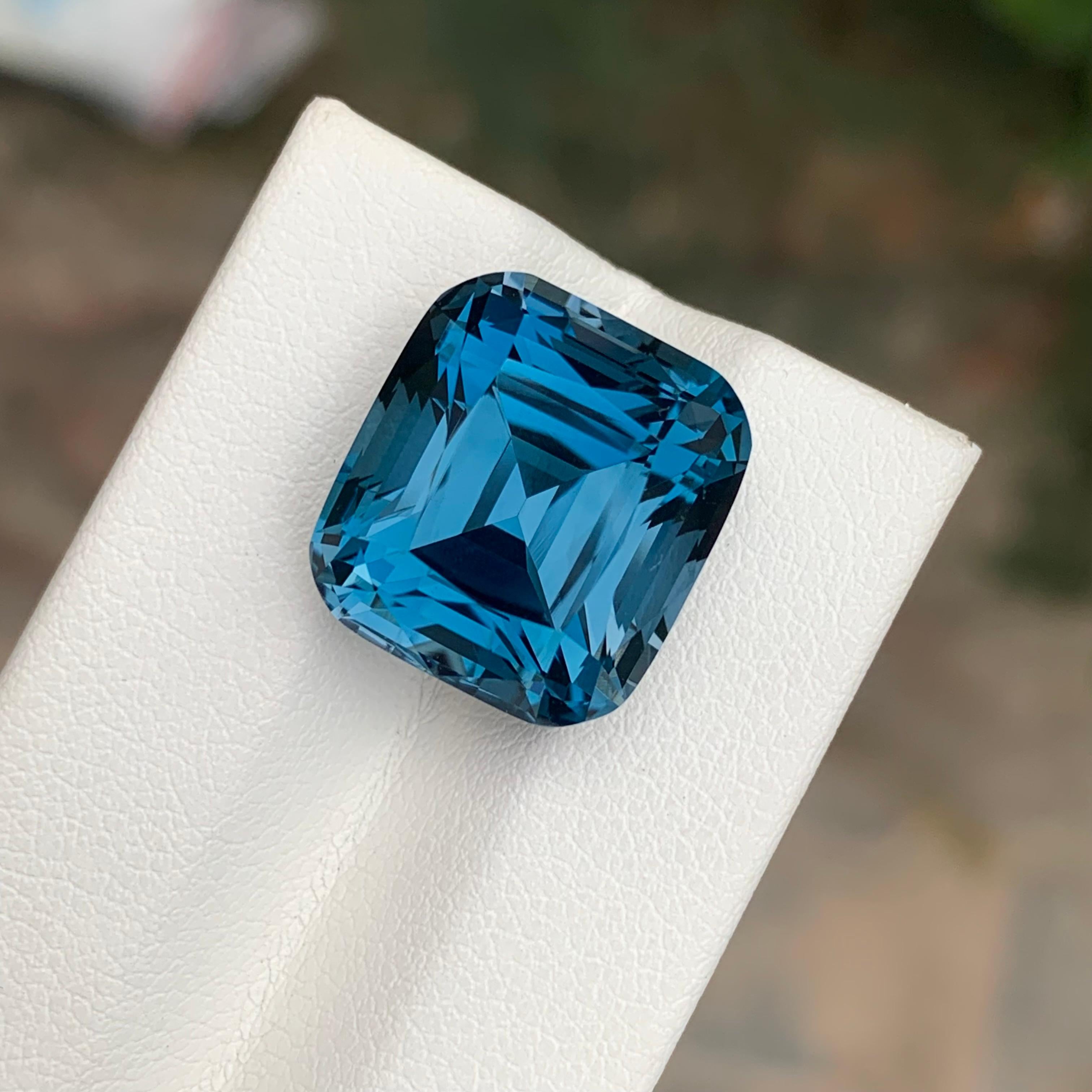 Loose London Blue Topaz 

Weight: 19.60 Carats
Dimension: 14.9 x 13.6 x 11.2 Mm 
Origin: Brazil
Shape: Cushion 
Color: Deep Blue
Certificate: On Customer Demand

London Blue Topaz is a mesmerizing variety of topaz renowned for its deep and