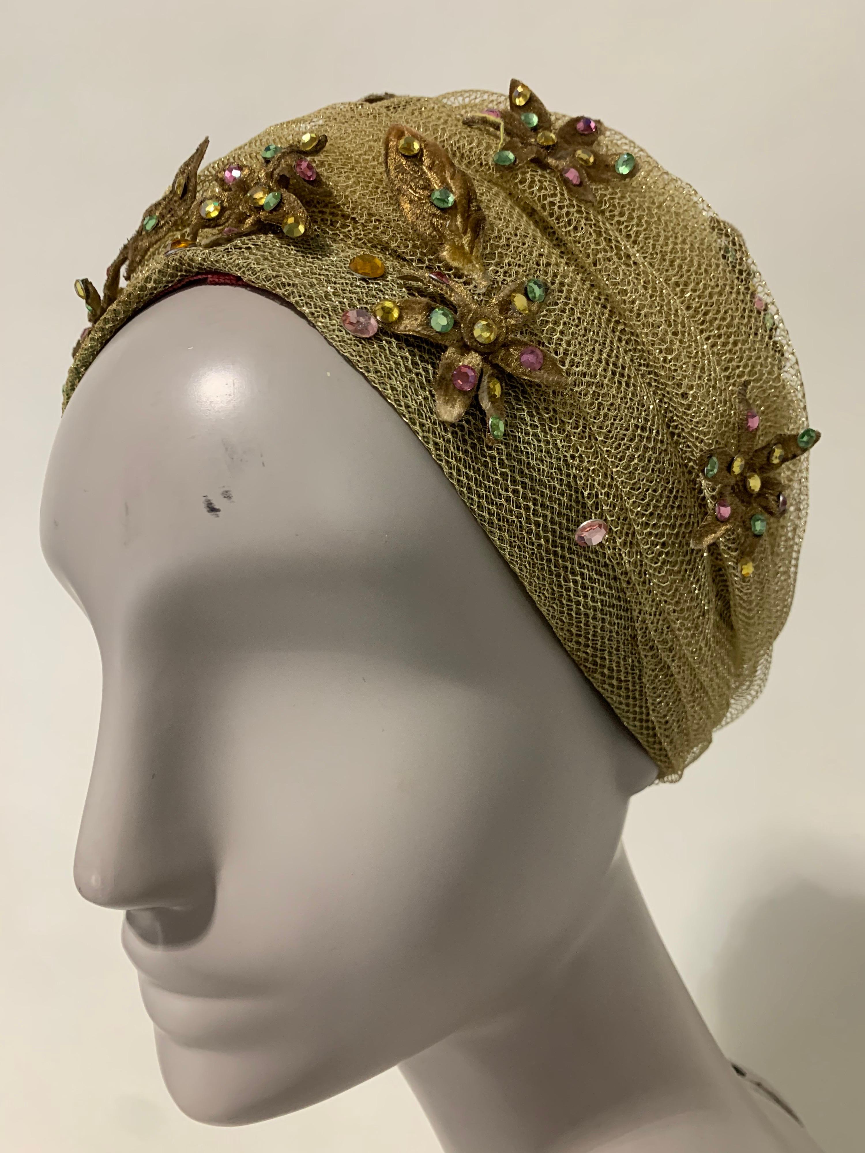 1960s Christian Dior gold mesh turban hat with metallic fabric flowers sprinkled with multicolor rhinestones. Theatrical glamour by Marc Bohan for Christian Dior. Grosgrain inner band. Size Medium.