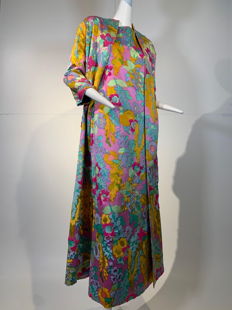 1960s Custom-made Mod floral resort ensemble: A lovely pastel mod floral maxi gown and coat set, in a lightweight flocked silk satin with beaded petals throughout. Jacket has deep side vents and is lined in azure blue. Gown buttons closed at side.