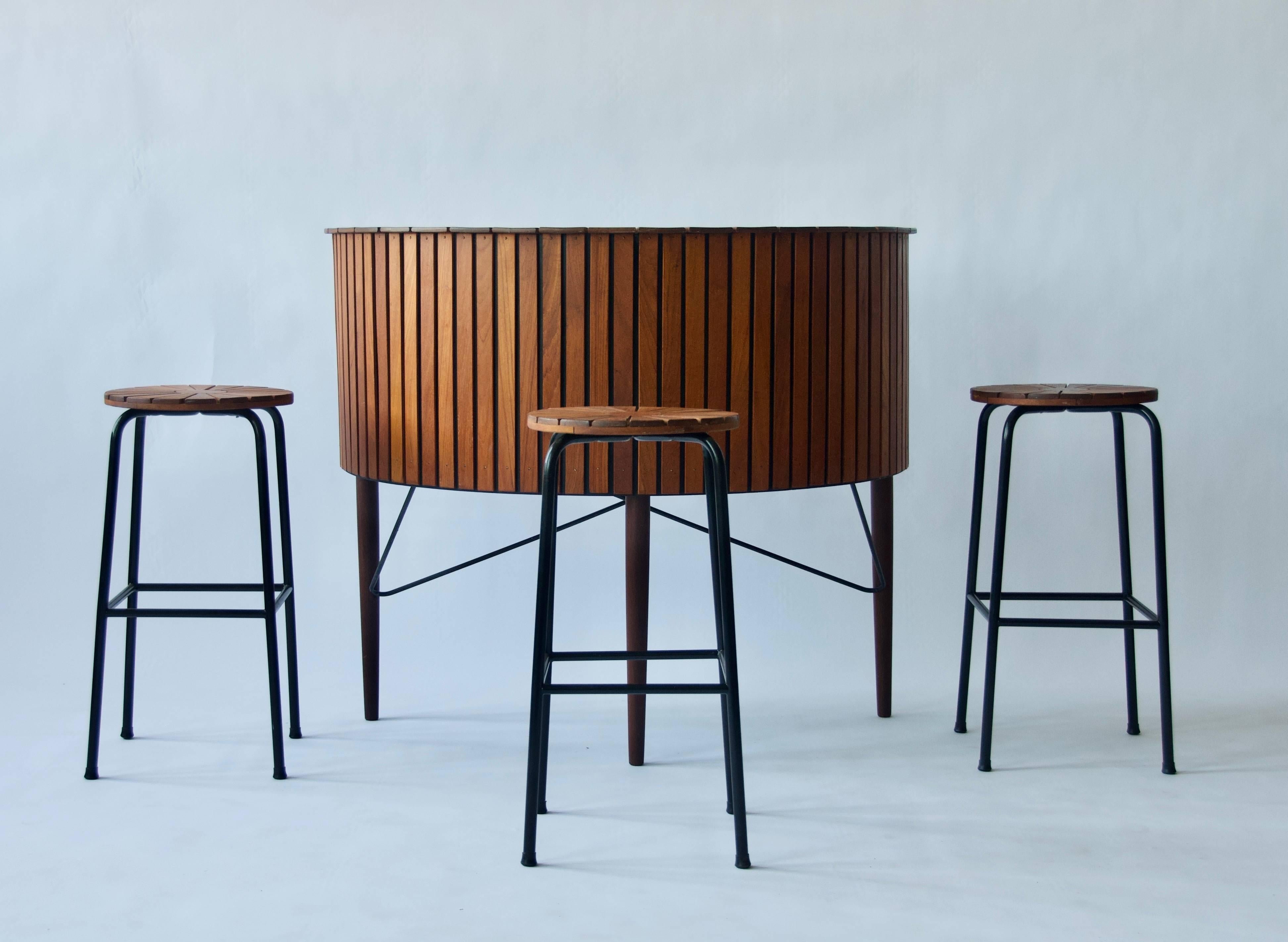 1960s Danish bar and stools. Three stools with metal frames. Teak
Bar measures 48 W x 25 D x 41 height. Stools 28 high.