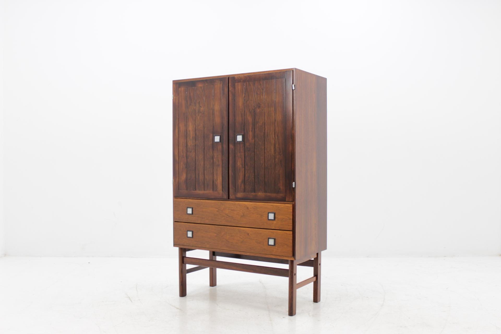This cabinet features two doors compartment with inner shelves and two drawers. The item was carefully restored.