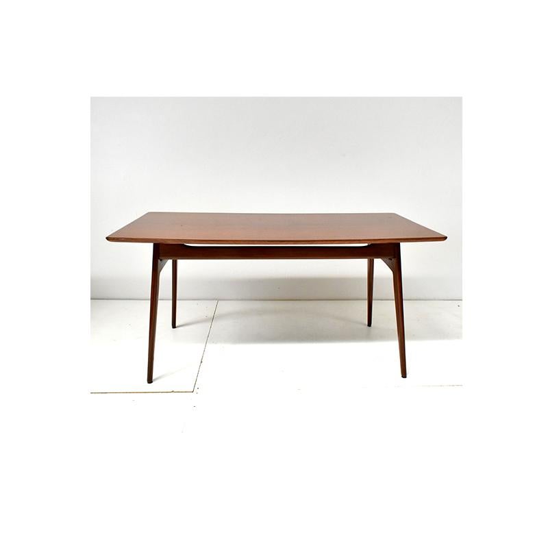Vintage 60s table, Danish style.
Rectangular wooden structure.
The corners of the table are slightly rounded.