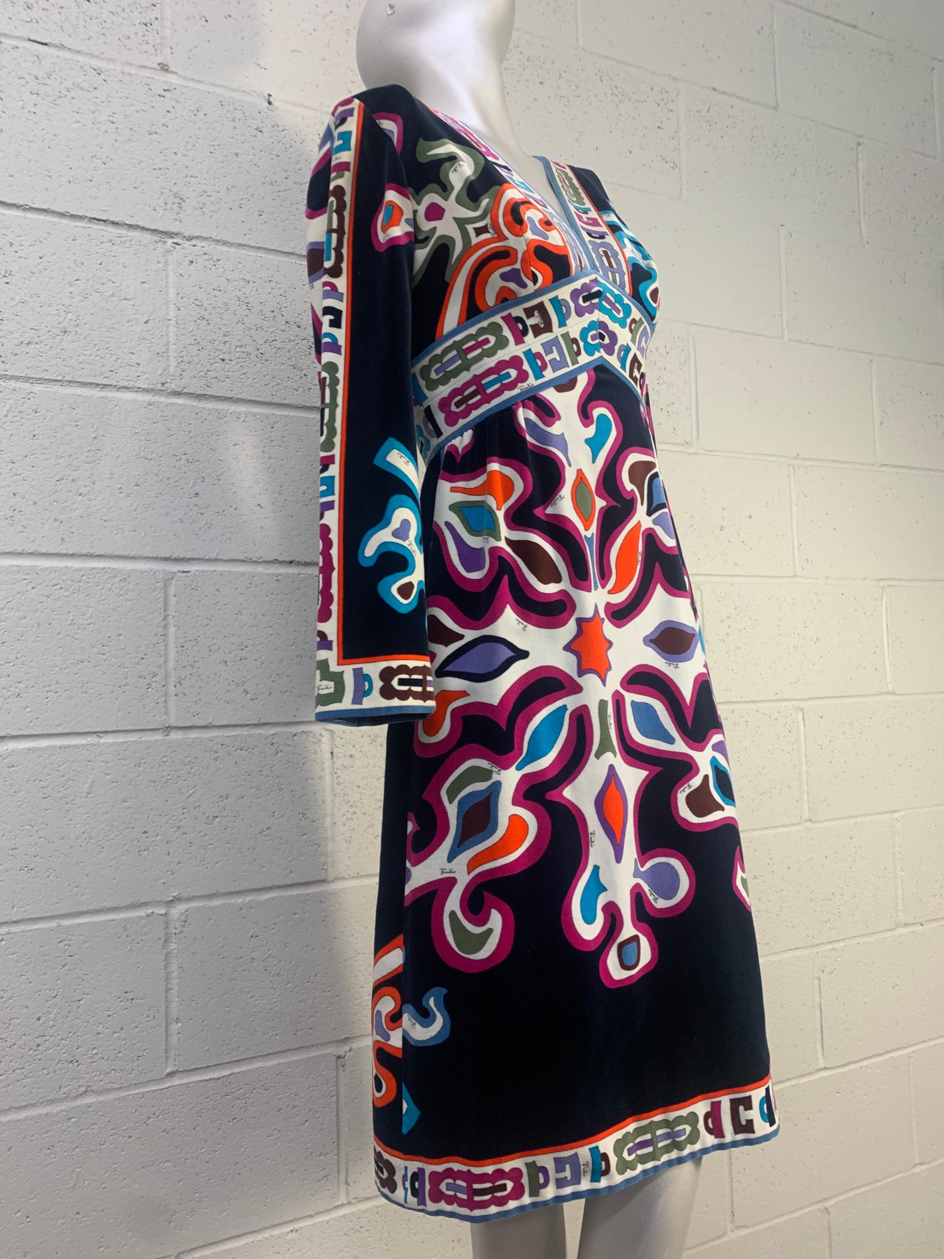 A wonderful 1960s Emilio Pucci cotton velveteen knee-length dress in classic Pucci colorful print, V-neck line, Empire waist, and long sleeves. Side and back zipper. Fully lined. US size 4.