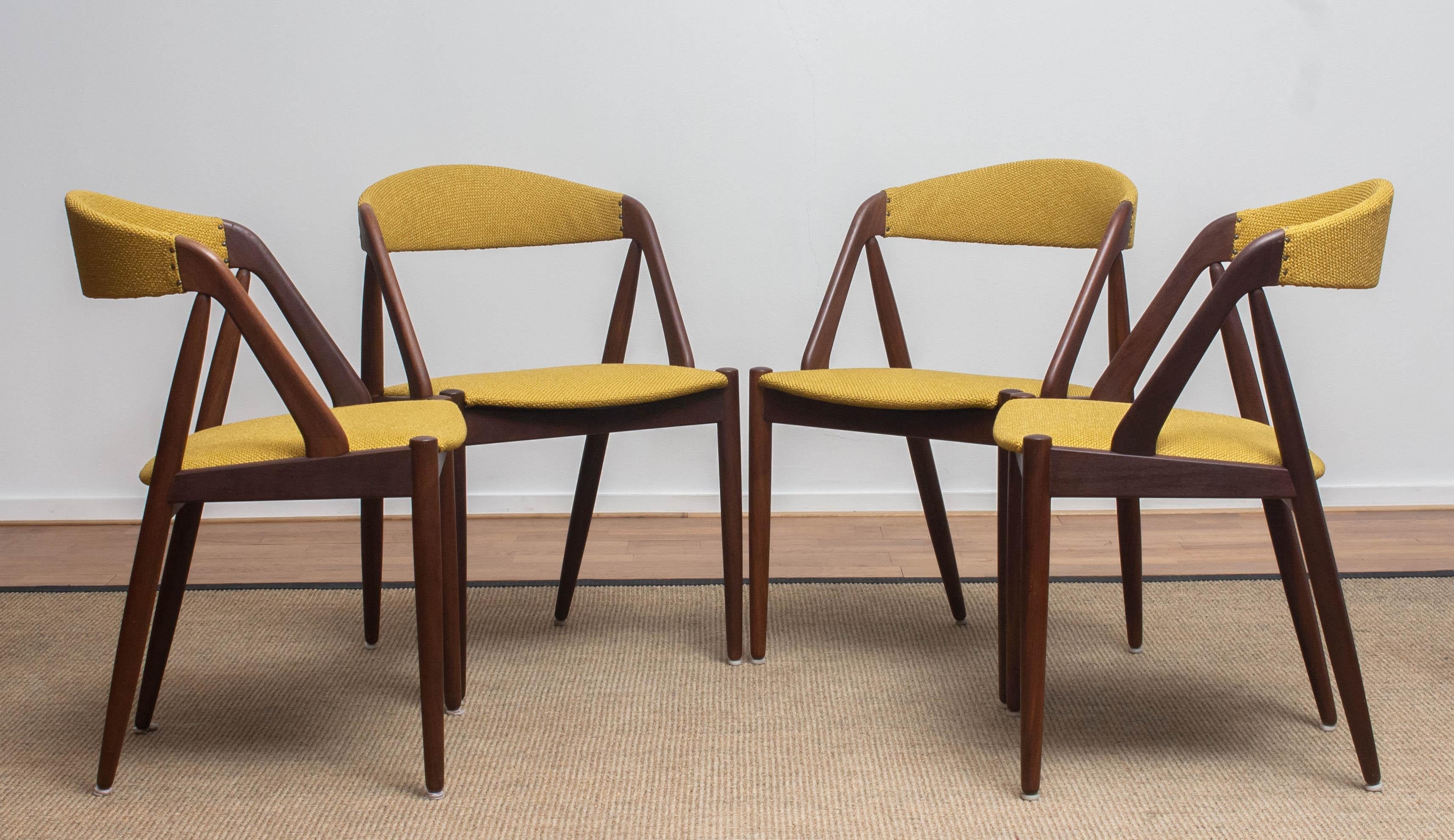 A beautiful set of four dining chairs by Kai Kristiansen for Shou-Andersen Møbelfabrik. The chairs are made of walnut frames with new ochre / gold color upholstery. They are in a wonderful condition. Period: 1960s.