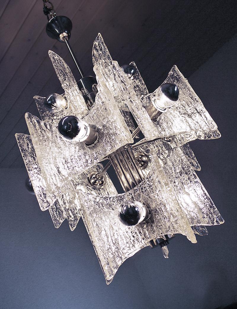 Elegant Mid-Century Modern chandelier with large handblown semicircular iced Murano glasses on a chromed frame. Chandelier illuminates beautifully and offers a lot of light. Manufactured by Kaiser Lighting, Germany in the 1960s. 

Materials: Murano