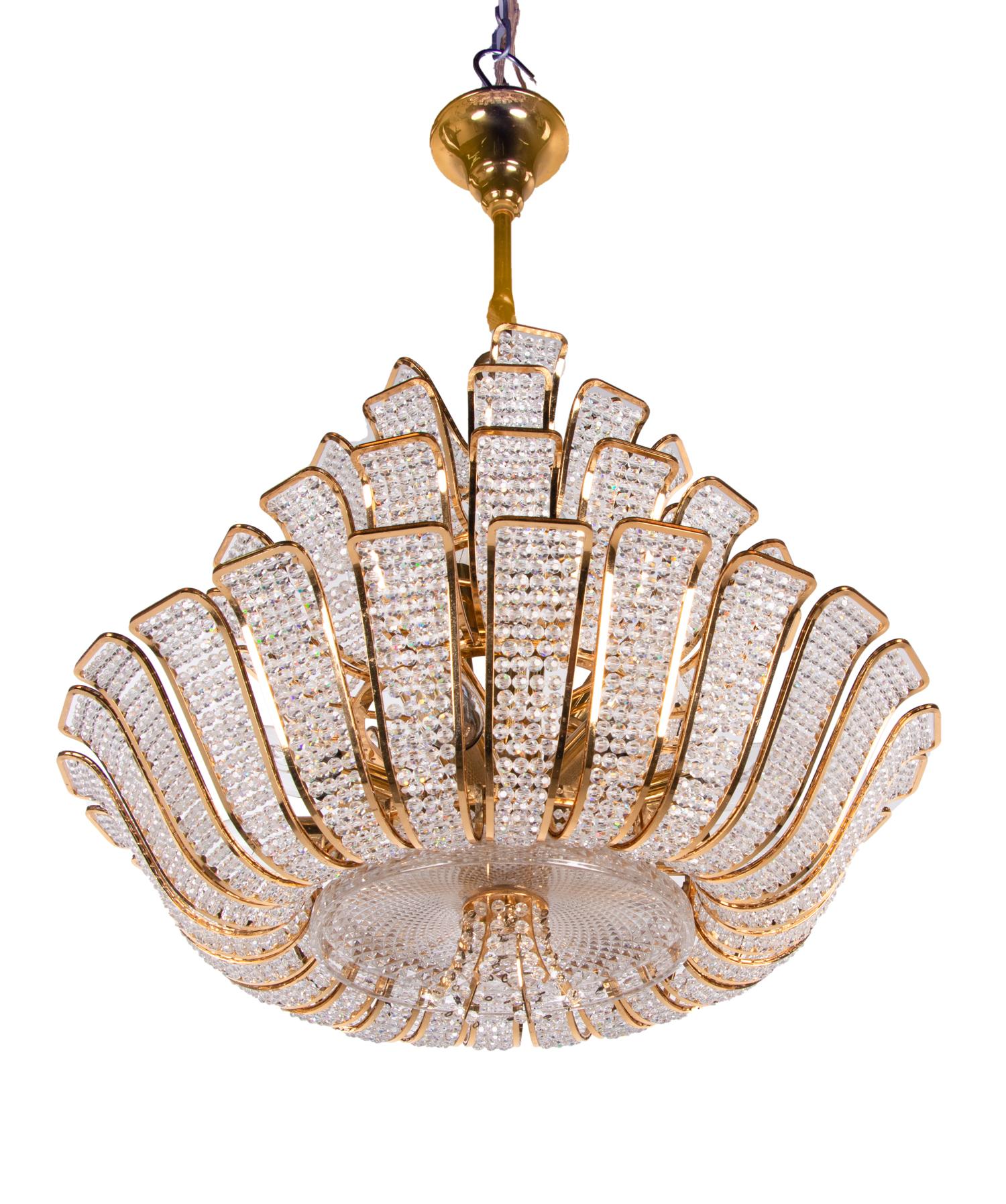 Glamorous chandelier made of a 24-carat gold-plated brass frame with crystal pearlss. 
Manufactured by Palwa (Palme & Walter), Germany in the 1960s. 

Style: Hollywood Regency. 
Colors: clear and golden. 
Materials: crystal glass and gilt